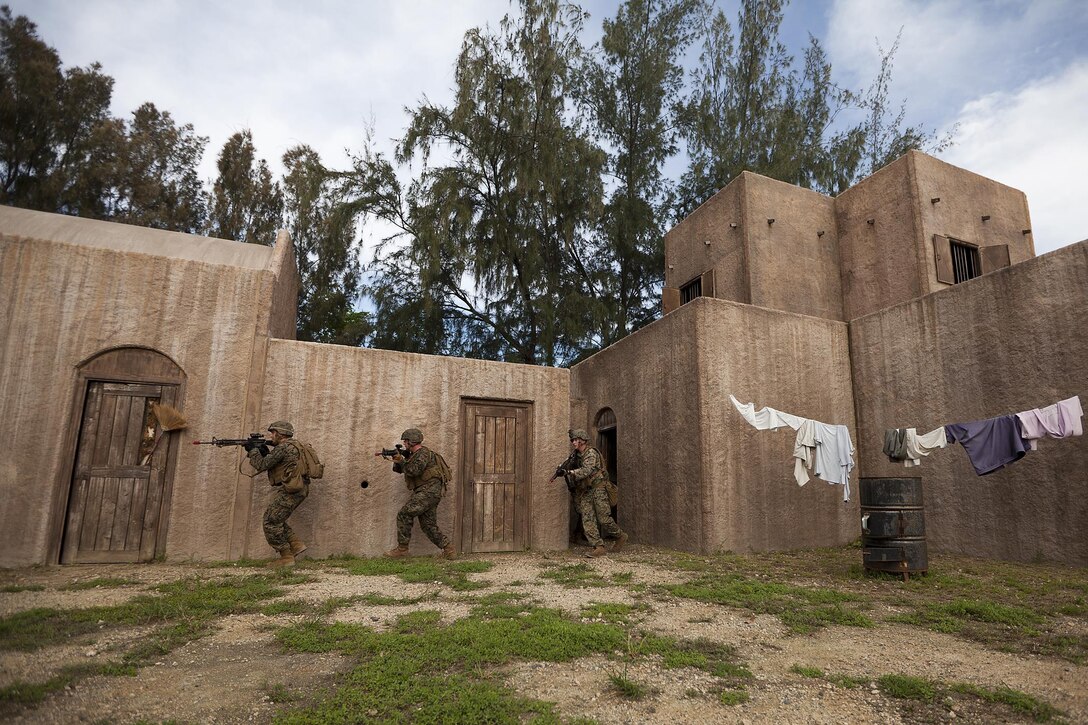 Marines with third platoon, Charlie Company, 1st Battalion, 3rd Marine Regiment, advance positions as they clear each room in a military operations on urban terrain facility during a battalion-level training exercise at Marine Corps Training Area Bellows, Nov. 19, 2013. The Marines received realistic training as they face opposing forces during the assault, which were played by fellow Marines within the company. (U.S. Marine Corps photo by Lance Cpl. Matthew Bragg)