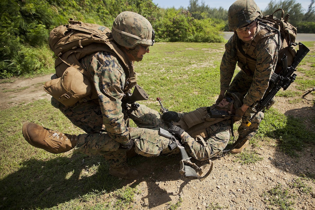 Cpl. Noel Desantiago (center), squad leader for first platoon, Charlie Company, 1st Battalion, 3rd Marine Regiment, and a 23-year-old native of Porterville, Calif., is carried to safety after being “shot” by opposing forces during a battalion-level training exercise at Marine Corps Training Area Bellows, Nov. 19, 2013. (U.S. Marine Corps photo by Lance Cpl. Matthew Bragg)