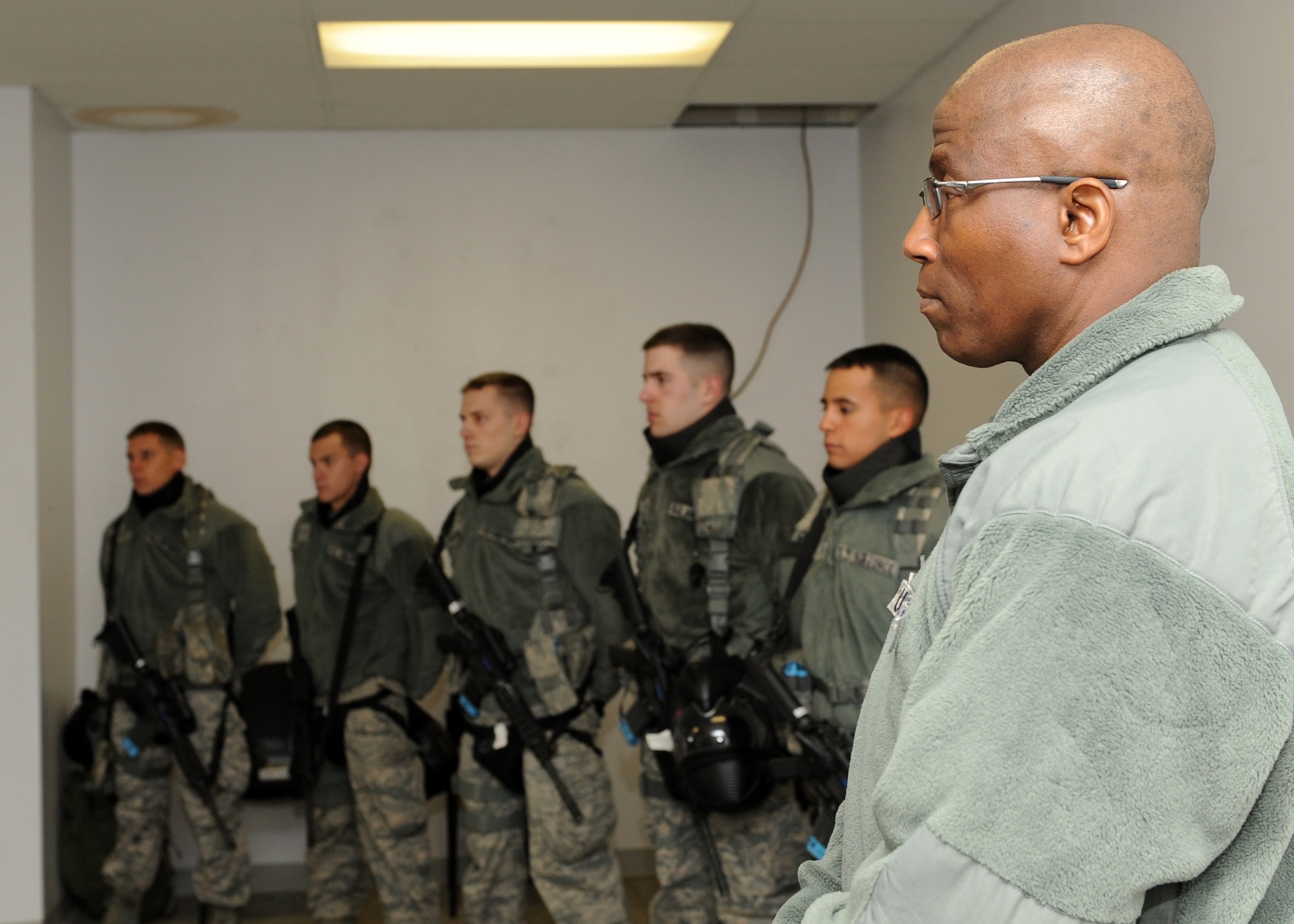 Brig. Gen. Allen J. Jamerson, Air Force Security Forces director and deputy chief of staff for logistics, installations and mission support, listens to a briefing before a live training exercise Nov. 21, 2013, at Buckley Air Force Base, Colo. Jamerson and Chief Master Sgt. Stephen White, Air Force Security Forces career field manager, visited Buckley during their weeklong tour of security forces units. (U.S. Air Force photo by Senior Airman Marcy Copeland/Released)