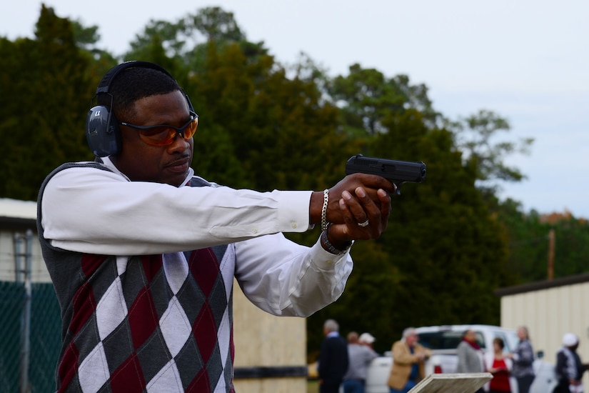 Lorenzo Riddick, 733rd Mission Services Division director, shoots his 9mm pistol during the opening ceremony of a new privately-owned weapons range at Fort Eustis, Va., Nov. 22, 2013. The range is open to all active-duty Service members, dependents, retirees and Department of Defense personnel. (U.S. Air Force photo by Staff Sgt. Ashley Hawkins/Released)