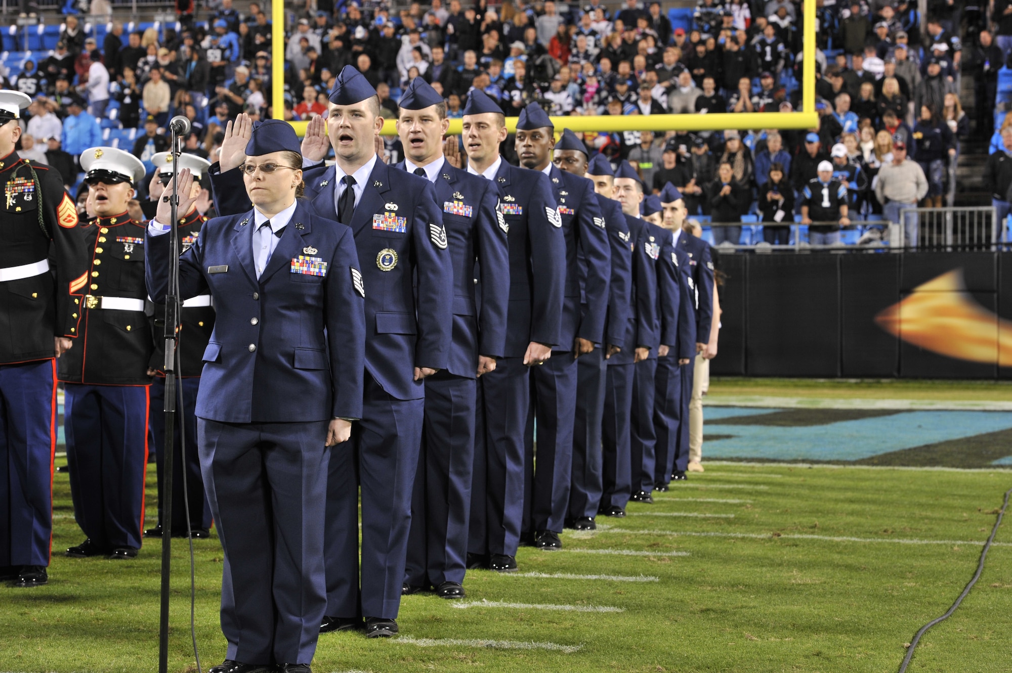 U.S. Air Force Airmen participate in a re-enlistment ceremony before the start of the Carolina Panthers verses New England Patriots game at Bank of America Stadium in Charlotte, N.C.,  Nov. 18, 2013. The game was the Panthers’ salute to service game and included a re-enlistment ceremony, a Purple Heart awarding and service members leading the Panthers out of the tunnel. (U.S. Air Force photo by Airman 1st Class Jonathan Bass/Released)
