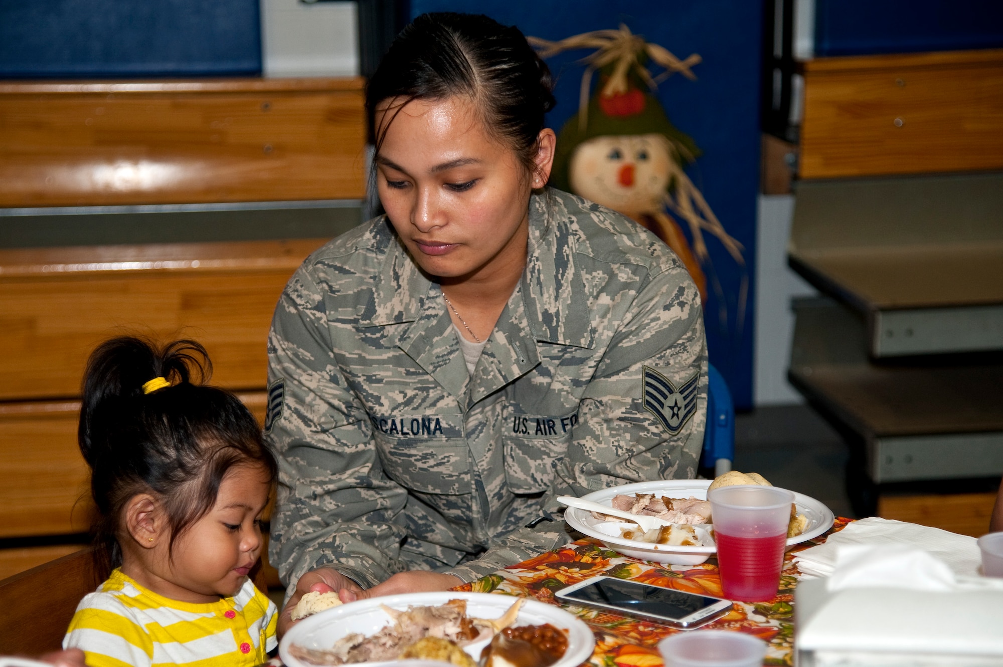 Staff Sgt. Grace Escalona, 505th Communications Squadron client systems technician, feeds her daughter, Skylynne Escalona, 1, during the youth center’s Thanksgiving dinner on Hurlburt Field, Fla., Nov. 21, 2013. The meal provided an opportunity for parents, their children and youth center staff to come together and celebrate the holiday. (U.S. Air Force photo/Senior Airman Michelle Vickers)