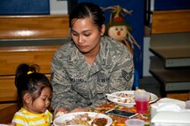 Staff Sgt. Grace Escalona, 505th Communications Squadron client systems technician, feeds her daughter, Skylynne Escalona, 1, during the youth center’s Thanksgiving dinner on Hurlburt Field, Fla., Nov. 21, 2013. The meal provided an opportunity for parents, their children and youth center staff to come together and celebrate the holiday. (U.S. Air Force photo/Senior Airman Michelle Vickers)