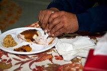 Joe Ramirez, 1st Special Operations Force Support Squadron maintenance technician, cuts turkey for his daughter, Joehanna Alcantara, 9, during a Thanksgiving meal at the youth center on Hurlburt Field, Fla., Nov. 21, 2013. The meal provided an opportunity for parents, their children and youth center staff to come together and celebrate the holiday. (U.S. Air Force photo/Senior Airman Michelle Vickers)