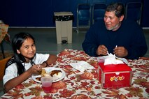 Joe Ramirez, 1st Special Operations Force Support Squadron maintenance technician, and his daughter, Joehanna Alcantara, 9, share a Thanksgiving meal at the youth center on Hurlburt Field, Fla., Nov. 21, 2013. The meal provided an opportunity for parents, their children and youth center staff to come together and celebrate the holiday. (U.S. Air Force photo/Senior Airman Michelle Vickers)