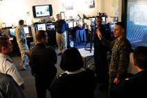 Ryan Burle, from “Inside CNN,” guides students from the Air Command and Staff College through the news network’s Headquarters facilities Nov. 20. The visit included discussion of military-media relations with Jim LeMay, consultant for CNN, and a subsequent trip to the Defense Video and Imagery Distribution System facility, also located in Atlanta. The students’ trip was part of the elective course “The War for Public Opinion,” produced by the U.S. Air Force Public Affairs Center of Excellence.  The course provides future leaders with an understanding of the impact of modern global information environment and the need for members of the armed forces at every level to be prepared to communicate effectively with the public they serve. (U.S. Air Force photo by Lt. Col. Don Langley)