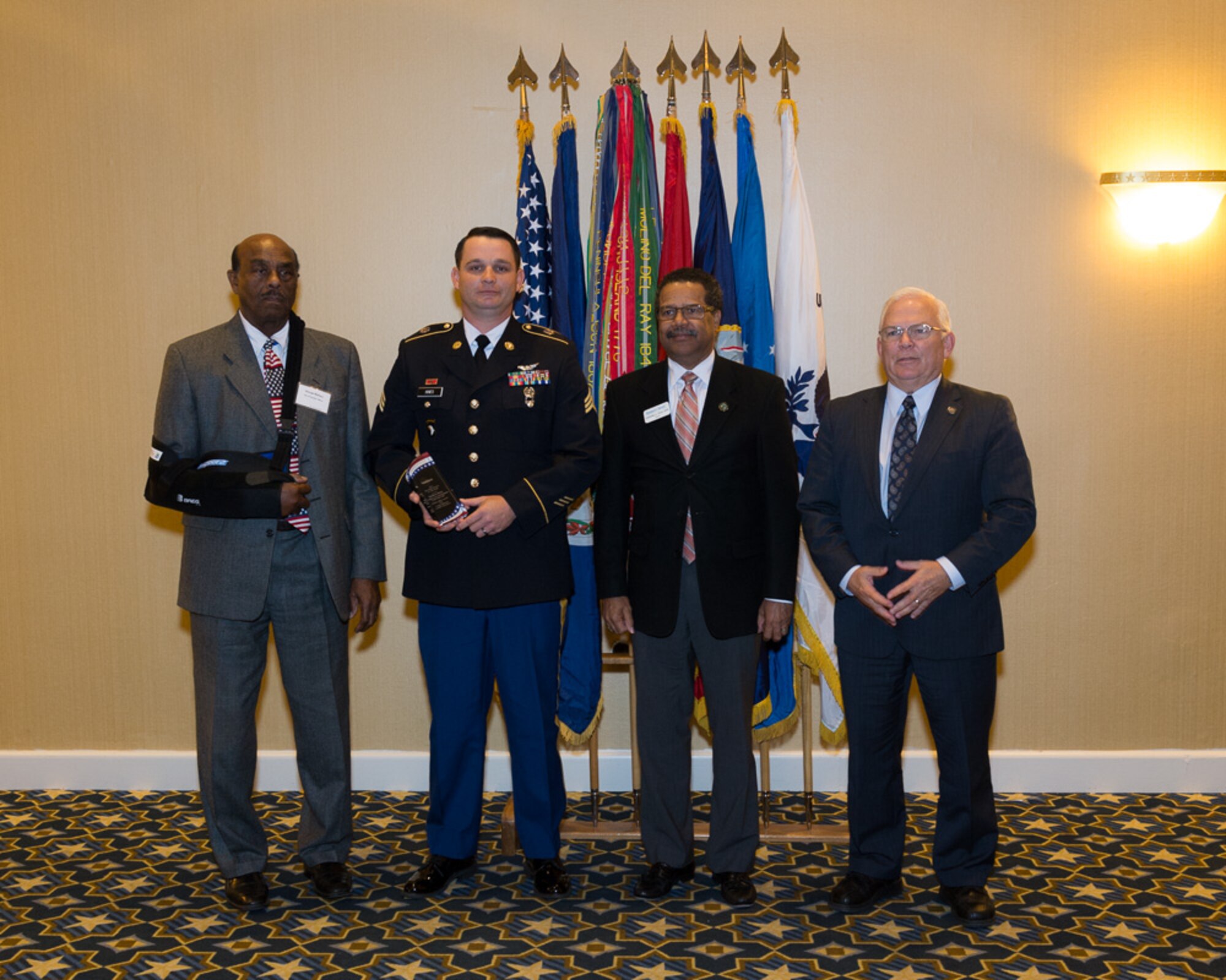 From left, George Wallace, city of Hampton Mayor, U.S. Army Sgt. Barry Hines, A-Company, 2nd Battalion, 210th Aviation Regiment instructor, McKinley Price, city of Newport News Mayor and Mike Kuhns, Virginia Peninsula Chamber of Commerce president, pose for a photo at the Military Citizen of the Year ceremony in Norfolk, Va., Nov. 12, 2013. Hines received the award, which was given to a member of each military branch, for his personal community impact and involvement  outside of military duties.  (Courtesy Photo)