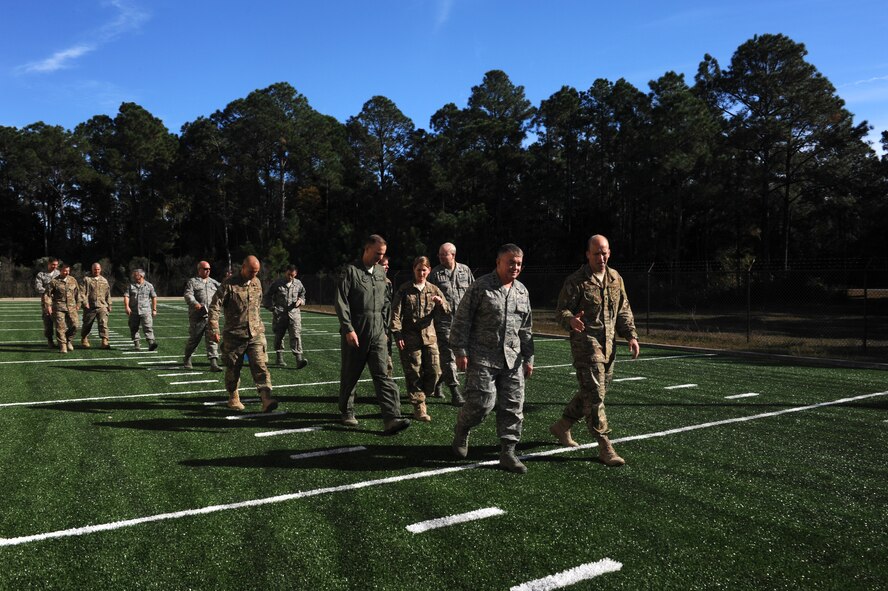 Lt. Gen. Thomas Travis, Air Force Surgeon General, walks with Air Commandos at the 23rd Special Tactics Squadron on Hurlburt Field, Fla., Nov. 19, 2013. Travis toured their physical training and therapy facilities to see the support they receive. (U.S Air Force photo/Senior Airman Naomi Griego)      