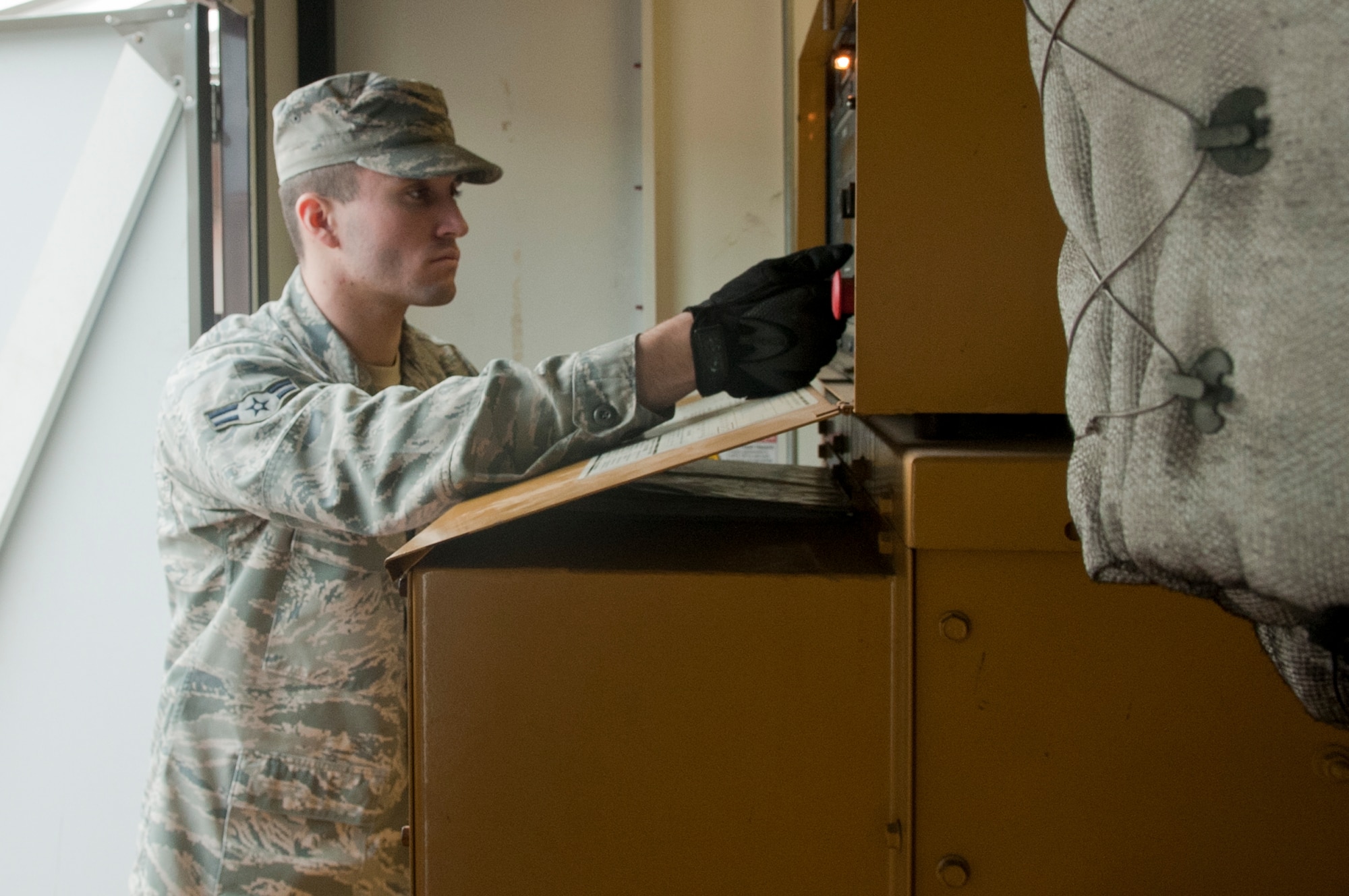 U.S. Air Force Airman 1st Class Christian Moore, 633rd Civil Engineer Squadron electrical power production journeyman, conducts preventative maintenance inspections on equipment at Langley Air Force Base, Va., Nov. 22, 2013.  The preventative maintenance initiative corrects faults in advance to limit the need for corrective maintenance.  (U.S. Air Force photo by Shaun Eagan/Released)  
