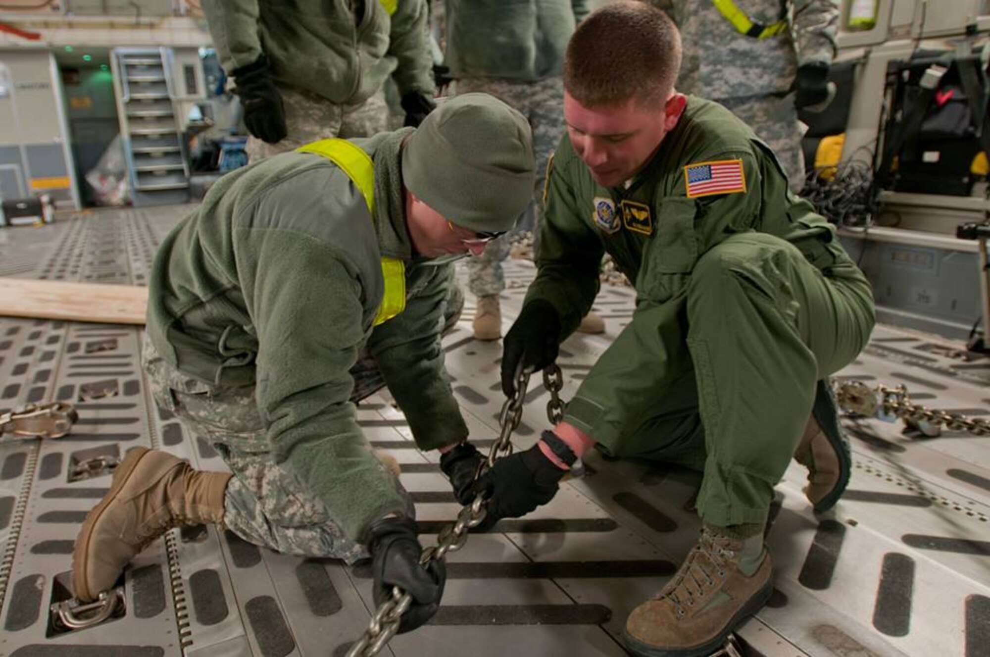 Airmen from Travis' 21st Airlift Squadron participated Nov. 13 in a joint Air Force/Army training with Soldiers from the 1st Brigade, 1st Infantry Division, and 1st Combat Aviation Brigade, 1st Infantry Division, at Manhattan Regional Airport in Manhattan, Kan. Working together, Soldiers and Airmen conducted loading procedures of the C-17 Globemaster III in order to train for rapid deployment readiness. (U.S. Army photo/Sgt. Michael Leverton)