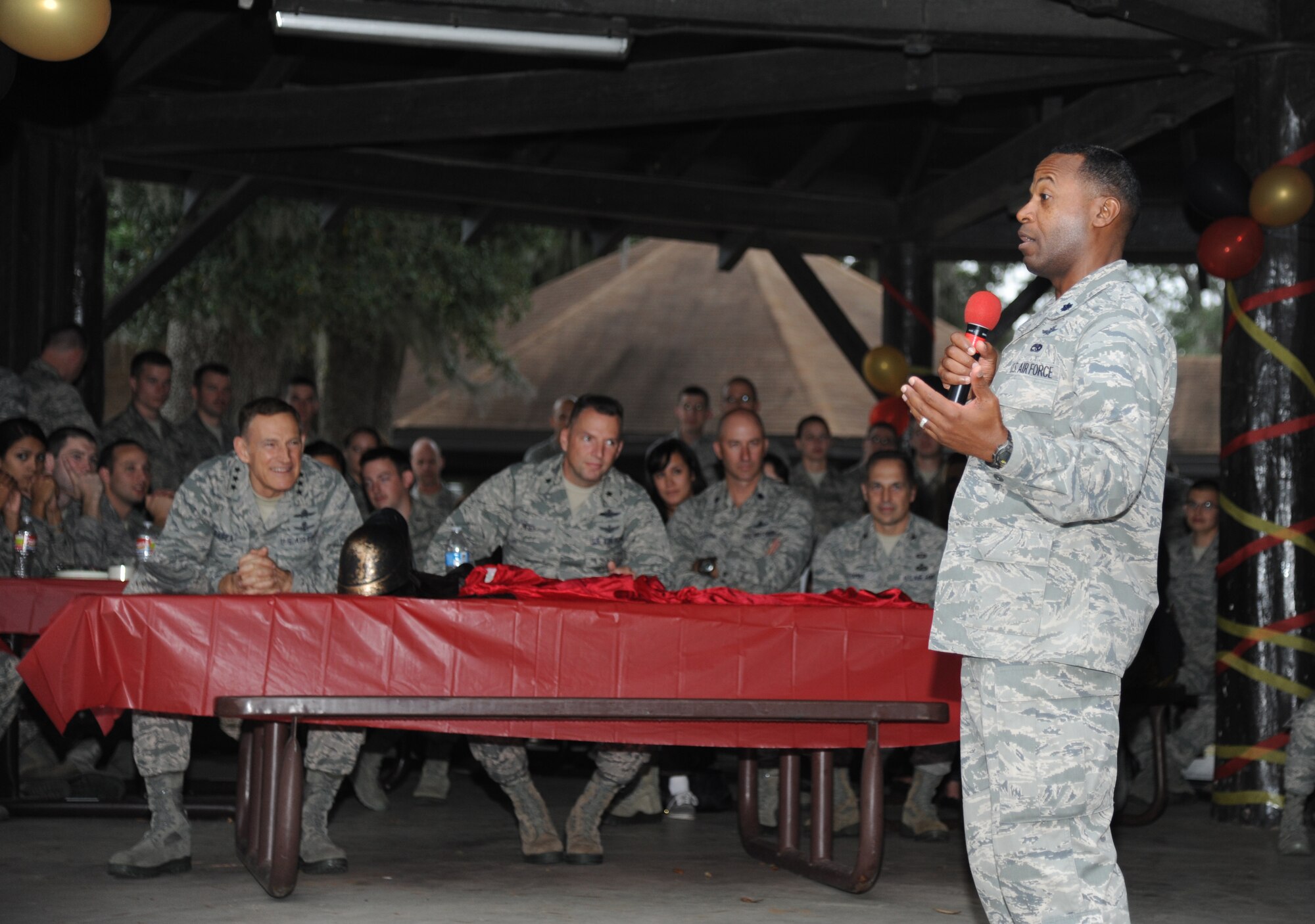 Lt. Col. Whitney McCloud, 333rd Training Squadron commander, congratulates the Undergraduate Cyberspace Officer Training course students on receiving their new assignments during the “Drop Night” event Nov. 21, 2013, at the marina, Keesler Air Force Base, Miss. The Spartan themed event also included the students playing the game, gladiator duels. (U.S. Air Force photo by Kemberly Groue)