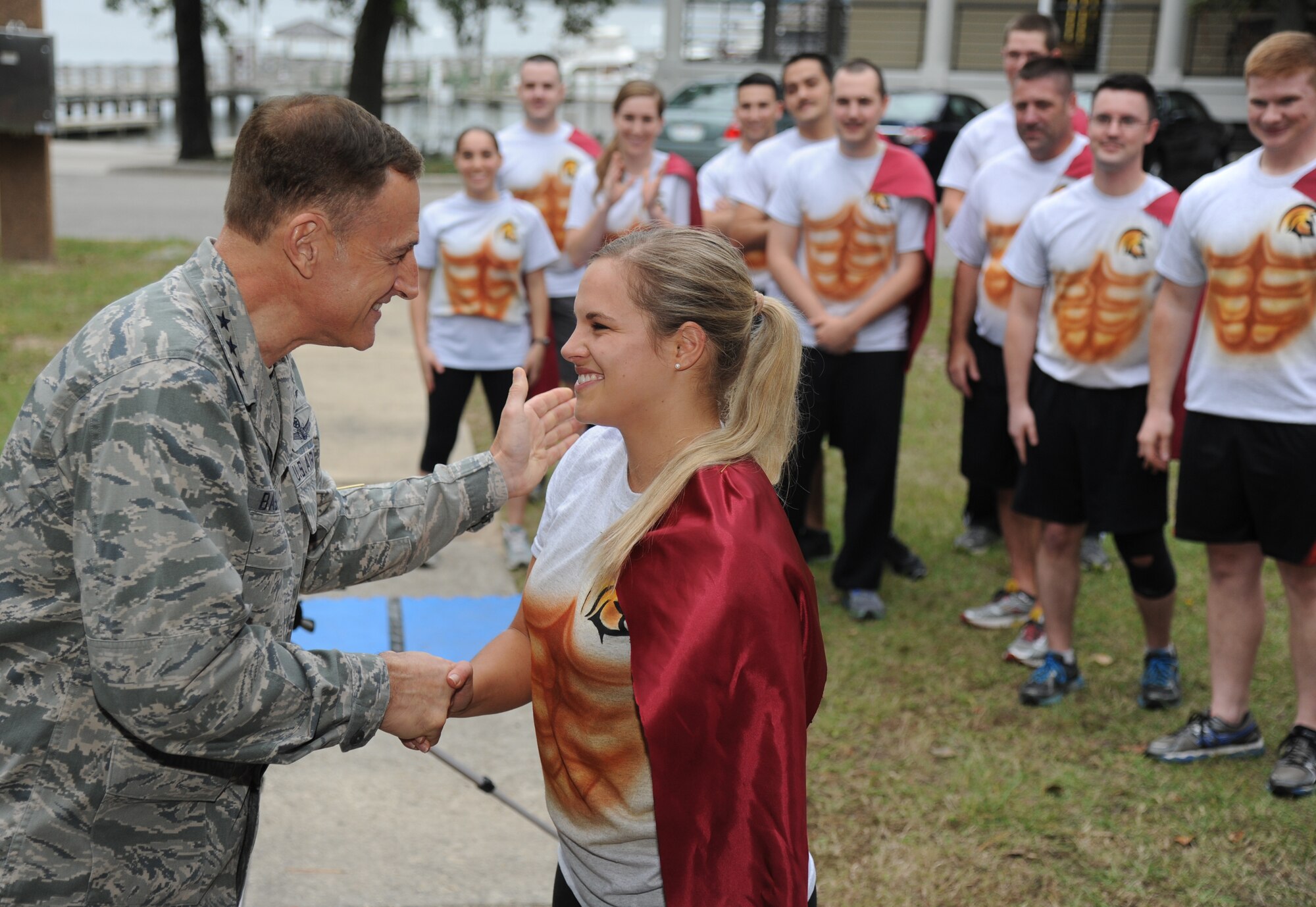 Lt. Gen. Michael Basla, Chief, Information Dominance and Chief Information Officer, Office of the Secretary of the Air Force, the Pentagon, Washington, D.C., congratulates 2nd Lt. Amanda Steele, 333rd Training Squadron Undergraduate Cyberspace Officer Training course student, after he presented her with her first assignment during the “Drop Night” event Nov. 21, 2013, at the marina, Keesler Air Force Base, Miss. The Spartan themed event included the UCT students receiving their first assignments and playing the game, gladiator duels. (U.S. Air Force photo by Kemberly Groue)