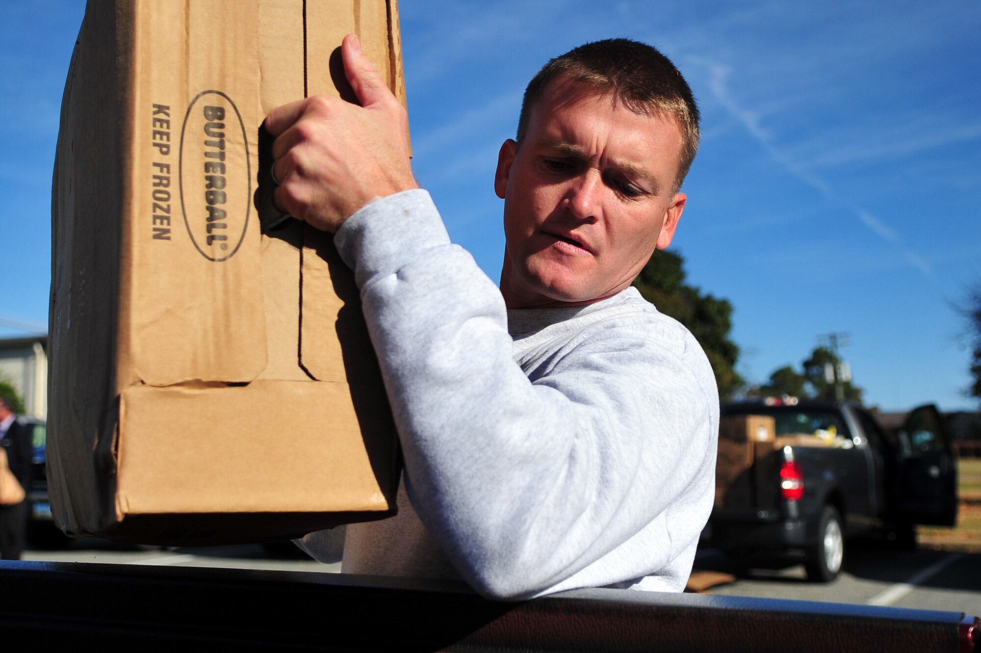 U.S. Air Force Master Sgt. Jonathan Mundt, 4th Communications Squadron first sgt., loads boxes of frozen turkeys donated by Butterball and the United Services Organization at Seymour Johnson Air Force Base, N.C., Nov. 22, 2013. The turkeys and other Thanksgiving meal items will be given to members of Team Seymour and their families who may need a little extra help during the holiday season.  (U.S. Air Force photo by Tech. Sgt. Brittany E. Jones)