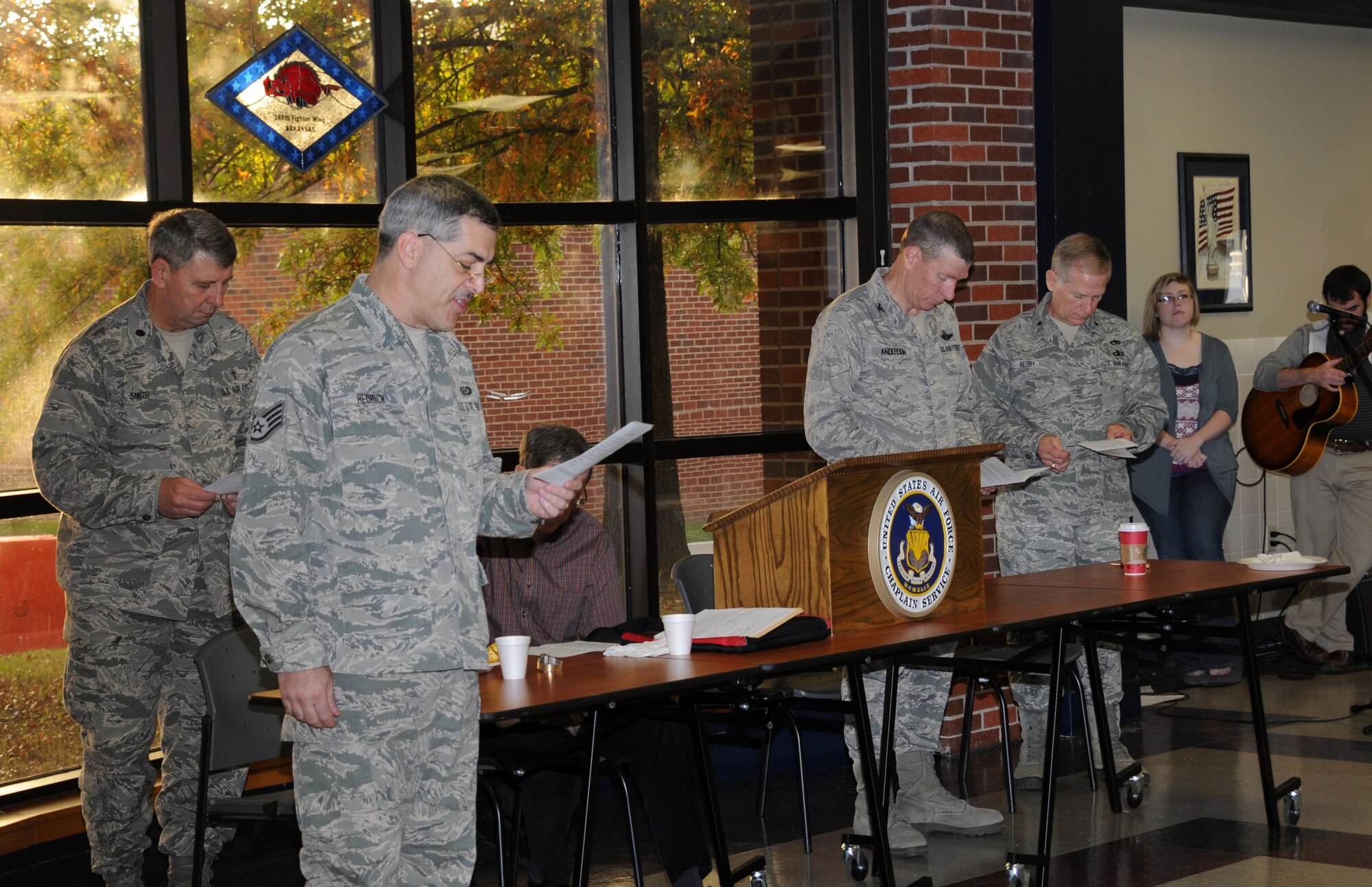Staff Sgt. Richard Hedrick, 188th Fighter Wing chaplain assistant, second from left, leads a gathering in prayer during a prayer breakfast at the 188th Fighter Wing’s Citizen Airmen Dining Hall Nov. 3. (U.S. Air National Guard photo by 1st Lt. Holli Nelson/188th Fighter Wing Public Affairs)