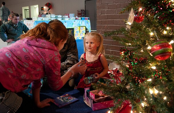 121215-F-JW079-102
Cartanya Severson, 12, helps Lynzee Smith, 5, open the presents she recieved from Santa during the Operation Provide Joy holiday event in the Fall Hall Community Center Dec. 15, 2012. The annual event gives local children a chance to spend time with F.E. Warren Airmen playing games, visiting with Santa and opening presents. This year’s the event takes place Dec. 14 from 8 a.m. to noon at Fall Hall. (U.S. Air Force file photo by R.J. Oriez)
