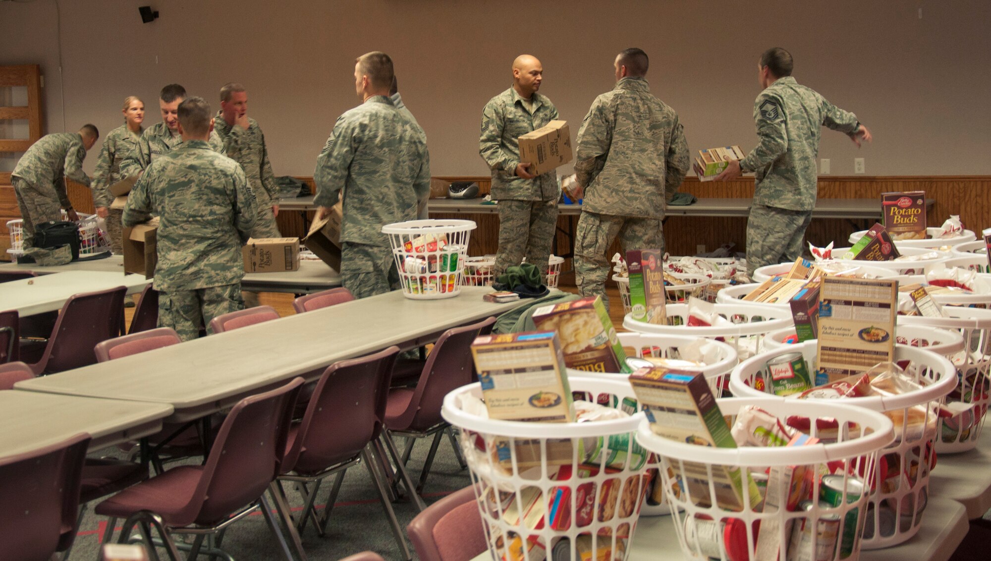 131122-F-GZ967-009 F.E. Warren’s First Sergeant Council works together to create food baskets Nov. 22 during their annual Thanksgiving Basket Food Drive. The baskets are stocked with food items that are common during the thanksgiving holiday, such as potatoes, green beans, stuffing, and corn, and brought to the Airmen who are struggling with financial difficulties during the holiday season. (U.S. Air Force photo by Airman 1st Class Brandon Valle)
