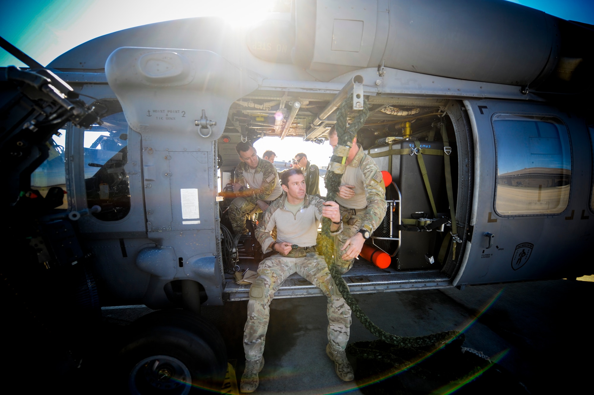 U.S. Air Force 1st Lt. Carl Schleich, 38th Rescue Squadron combat rescue officer shows Col. Chad Franks, 23d Wing commander, fast rope procedures during alternate insertion/extraction (AIE) training at Moody Air Force Base, Ga., Nov. 19, 2013. Training culminated with Franks practicing AIEs from an HH-60G Pave Hawk. (U.S. Air Force photo by Airman 1st Class Sandra Marrero/Released)
