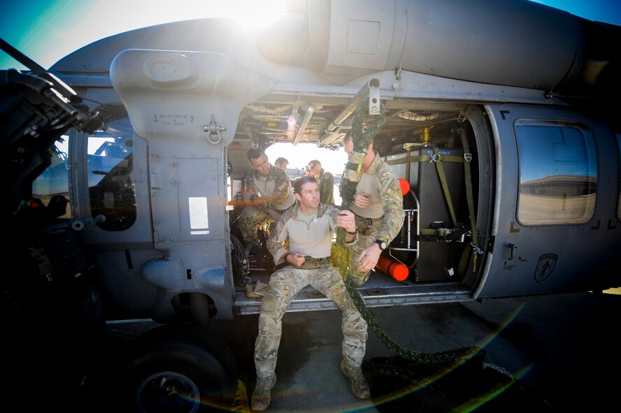 U.S. Air Force 1st Lt. Carl Schleich, 38th Rescue Squadron combat rescue officer shows Col. Chad Franks, 23d Wing commander, fast rope procedures during alternate insertion/extraction (AIE) training at Moody Air Force Base, Ga., Nov. 19, 2013. Training culminated with Franks practicing AIEs from an HH-60G Pave Hawk. (U.S. Air Force photo by Airman 1st Class Sandra Marrero/Released)
