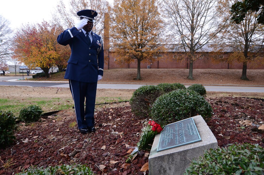 Master Sgt. Aaron Albright, 94th Airlift Wing Honor Guard superintendent, lays roses on a magnolia tree memorial on the 50th Anniversary of the assassination of John F. Kennedy, the 35th President of the United States Nov. 22 at Dobbins Air Reserve Base, Ga. Brig. Gen. George H. Wilson, Dobbins Air Force Base commander, ordered a tree be planted on base in memory of the President on Dec. 7, 1963. Members of Air Force Reserve units, the Marine Air Detachment, the Naval Air Station and the Georgia Air National Guard participated in the planting. (U.S. Air Force photo/Brad Fallin)