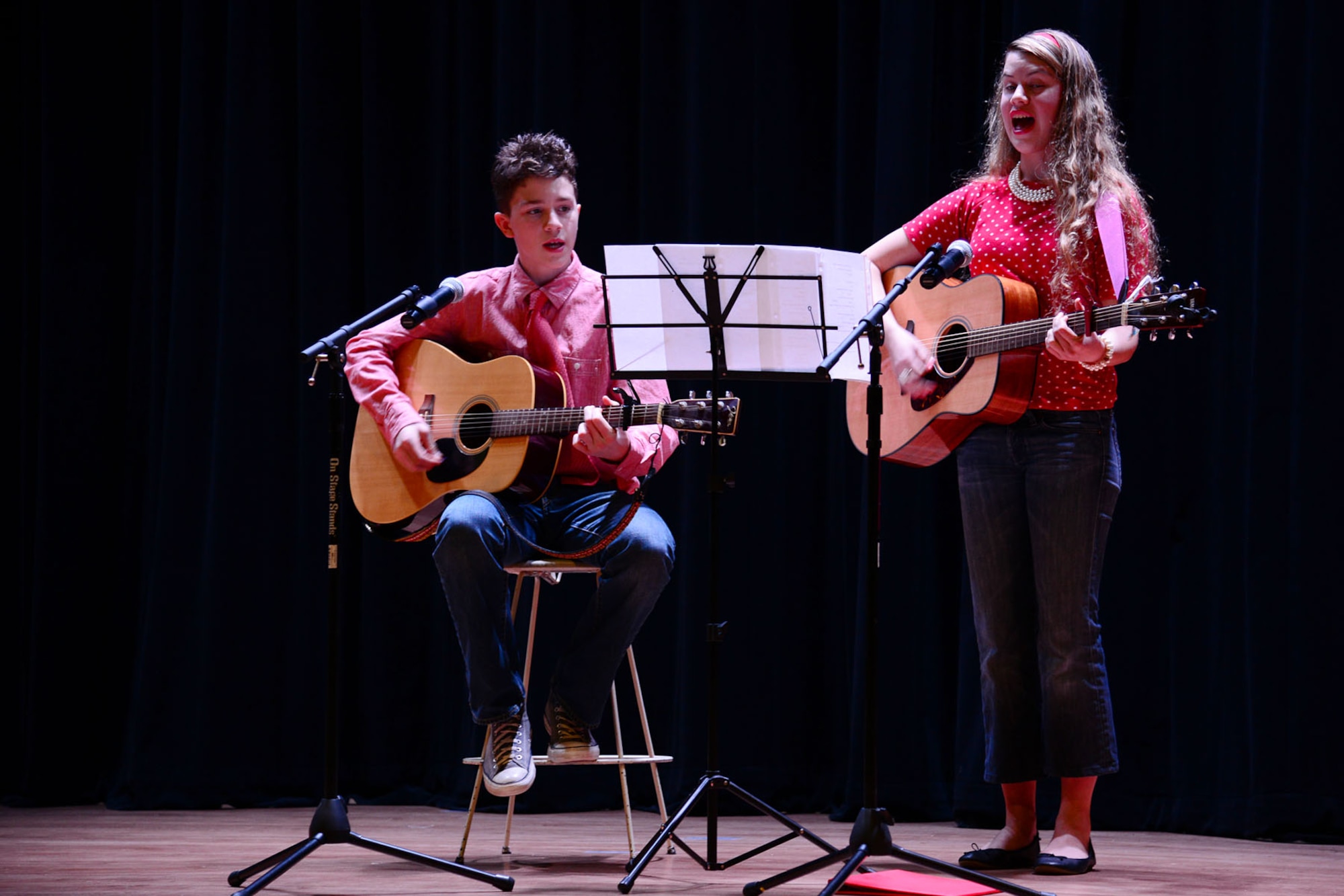 Jake and Madisson Rumfelt, children of U.S. Army Warrant Officer Ronald Rumfelt, Fort Eustis Warrant Officer Basic Course student,  perform gospel music during the talent show portion of the third annual “Thanks for Giving” potluck social at the 733rd Mission Support Group headquarters at Fort Eustis, Va., Nov. 21, 2013. The family, along with other local talents, volunteered to participate in the show to provide light-hearted entertainment for families of fallen Service members. (U.S. Air Force photo by Staff Sgt. Ashley Hawkins/Released)
