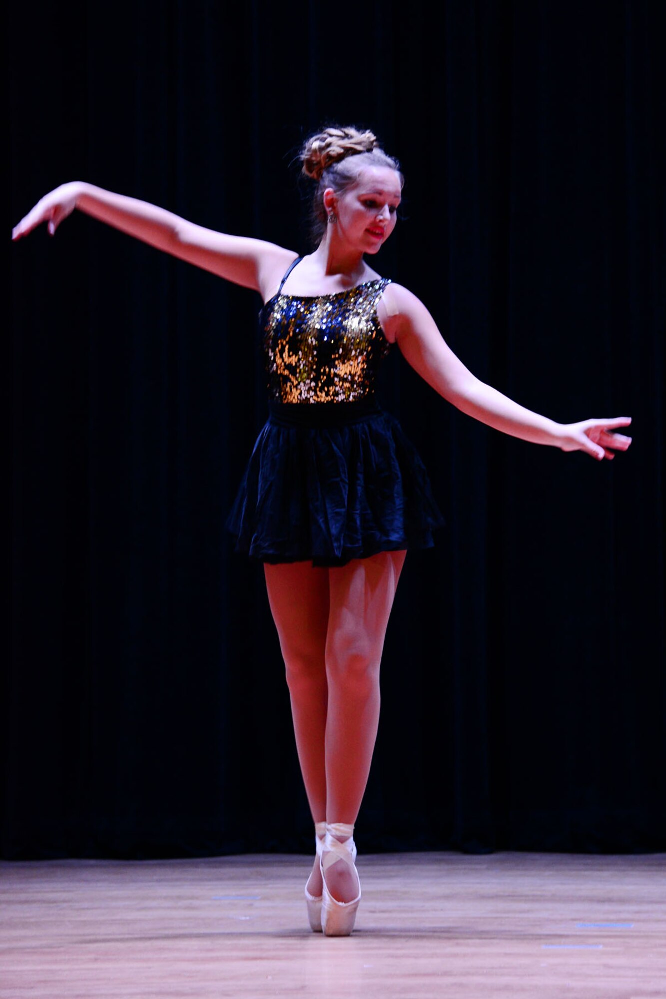 Kencie McDougall, daughter of a fallen U.S. Army Soldier, performs ballet during the talent show portion of the third annual “Thanks for Giving” potluck social at the 733rd Mission Support Group headquarters at Fort Eustis, Va., Nov. 21, 2013. The event drew nearly 70 participants, compared to 59 last year and 42 in 2010, with volunteers ranging from the United Service Organization, Marriot Hotels and even a family who traveled from San Diego. (U.S. Air Force photo by Staff Sgt. Ashley Hawkins/Released)