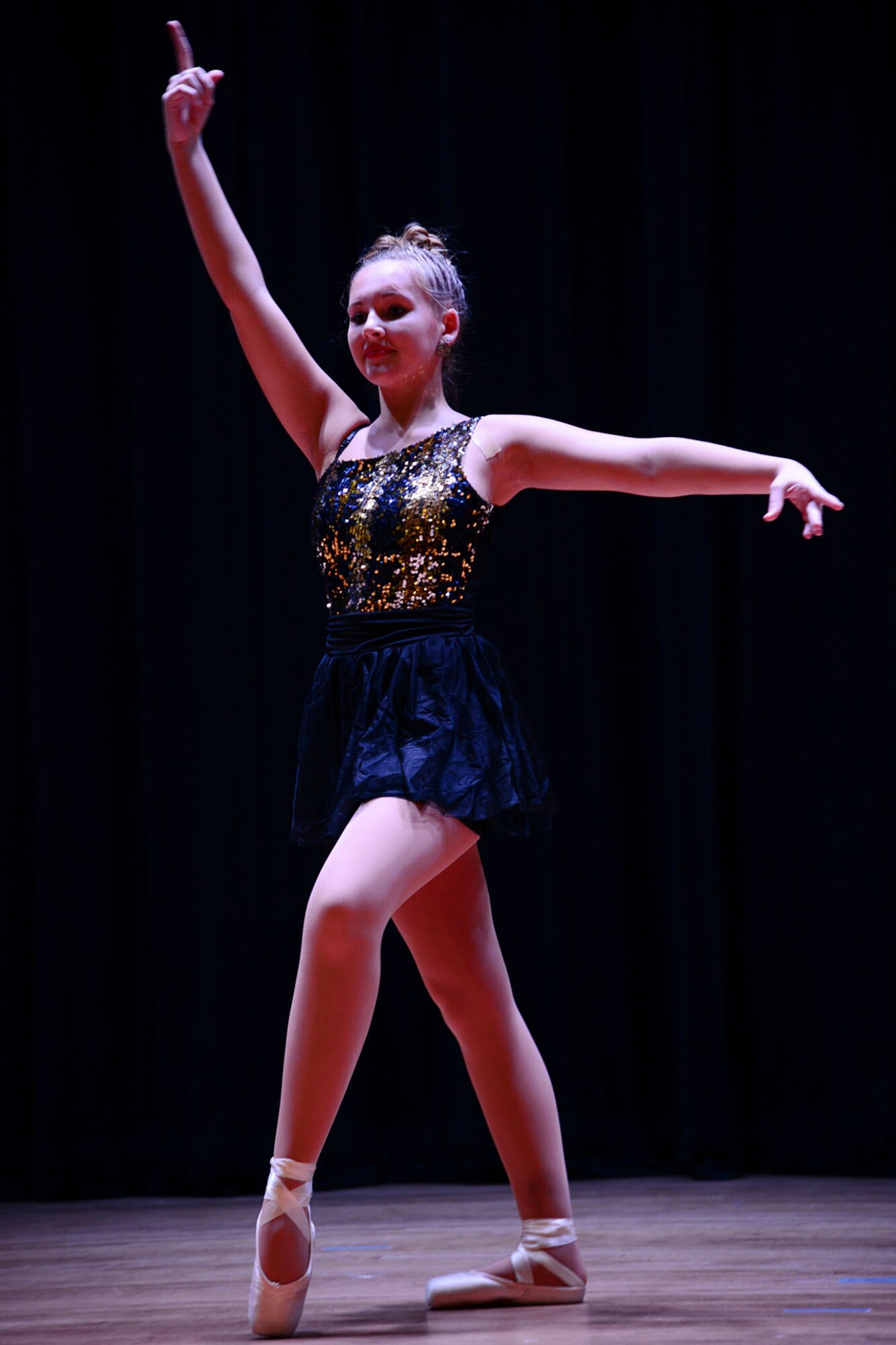 Kencie McDougall, daughter of a fallen U.S. Army Soldier, performs ballet during the talent show portion of the third annual “Thanks for Giving” potluck social at the 733rd Mission Support Group headquarters at Fort Eustis, Va., Nov. 21, 2013. The event drew nearly 70 participants, compared to 59 last year and 42 in 2010, with volunteers ranging from the United Service Organization, Marriot Hotels and even a family who traveled from San Diego. (U.S. Air Force photo by Staff Sgt. Ashley Hawkins/Released)