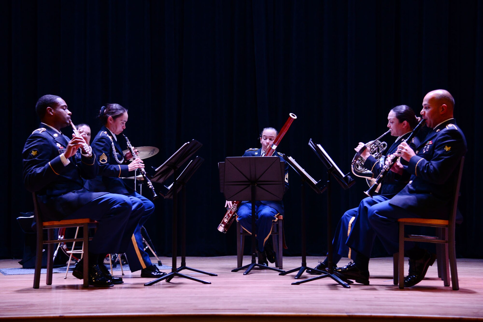 The U.S. Army Training and Doctrine Command band performs holiday music during the talent show portion of the third annual “Thanks for Giving” potluck social at the 733rd Mission Support Group headquarters at Fort Eustis, Va., Nov. 21, 2013. The show was held to provide entertainment and moral support for families who have lost a family member during their military service. (U.S. Air Force photo by Staff Sgt. Ashley Hawkins/Released)