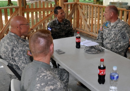 U.S. Army Col. Thomas Boccardi, Joint Task Force-Bravo Commander, U.S. Army Col. John Sena, Army Support Activity Commander, and U.S. Army Lt. Col. E.J. Irvin, 1-228th Aviation Regiment Commander, visit with Honduran Army Lt. Col. Santos Colindres, Deputy Commander of the Honduran 5th Infantry Batallion, at Mocoron, Honduras, Nov. 20, 2013. The military leaders discussed how Joint Task Force-Bravo can continue to assist and work together with the Honduran military, as well as the importance of continuing to build on the strong relationship between the United States and Honduras. (U.S. Air Force photo by Capt. Zach Anderson)