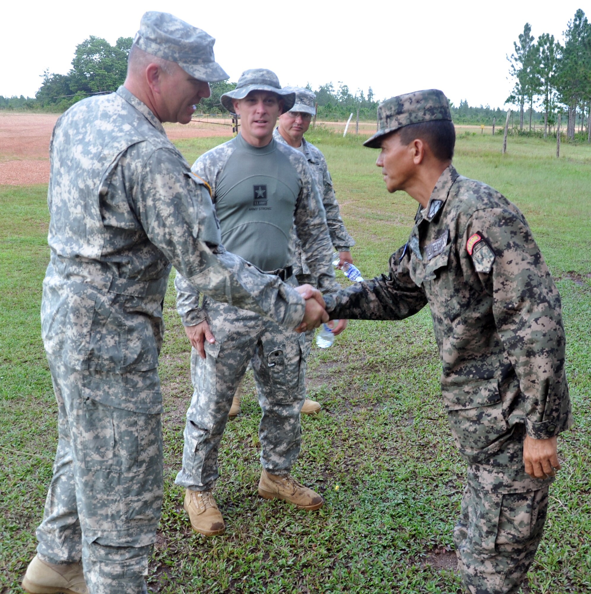 U.S. Army Col. Thomas Boccardi, Joint Task Force-Bravo Commander, is welcomed to Mocoron by Honduran Army Lt. Col. Santos Colindres, Deputy Commander of the Honduran 5th Infantry Batallion, at Mocoron, Honduras, Nov. 20, 2013. Boccardi and Colindres discussed how Joint Task Force-Bravo can continue to assist and work together with the Honduran military, as well as the importance of continuing to build on the strong relationship between the United States and Honduras. (U.S. Air Force photo by Capt. Zach Anderson)