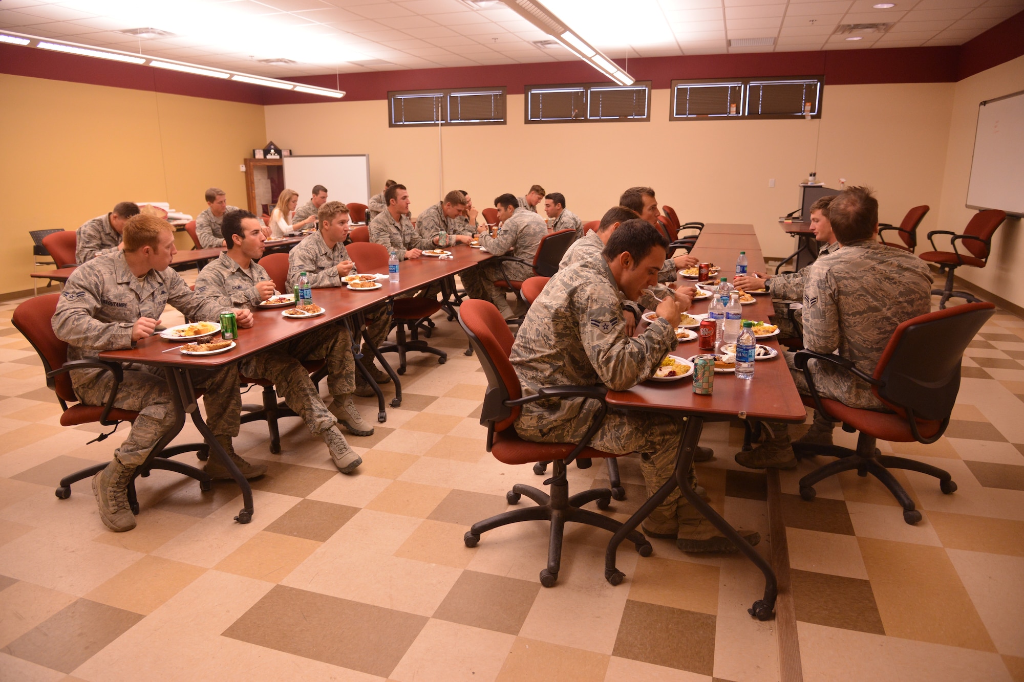 Pararescue trainees from the 342nd Training Squadron, Detachment 1, enjoy a Thanksgiving meal. The event, which has become an annual tradition, was organized by members of the AFRL Contracting Division with the help of donations from the local community.  (Photo by Ken Moore)