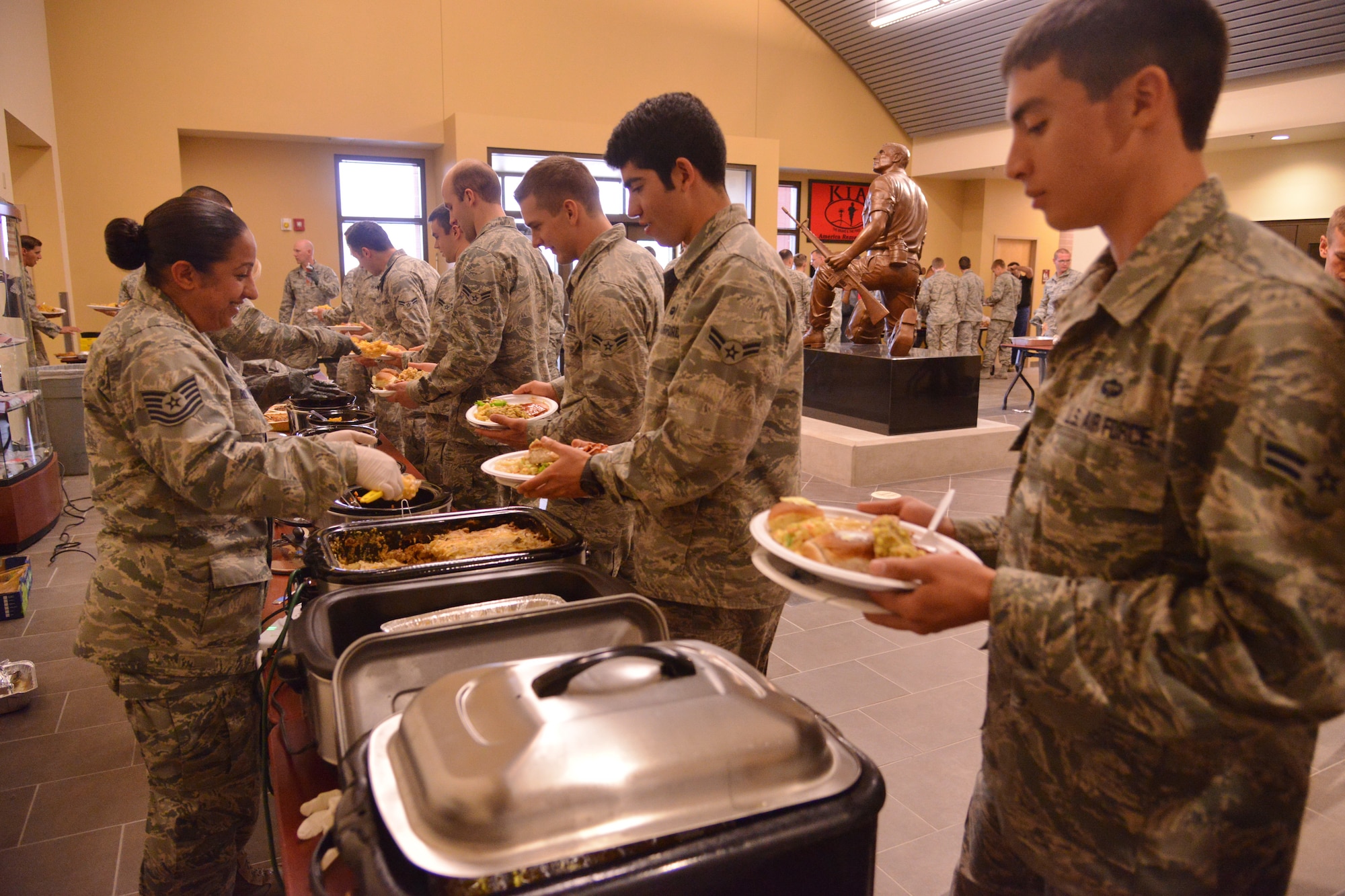 Pararescue trainees from the 342nd Training Squadron, Detachment 1, enjoy a Thanksgiving meal. The event, which has become an annual tradition, was organized by members of the AFRL Contracting Division with the help of donations from the local community.  (Photo by Ken Moore)