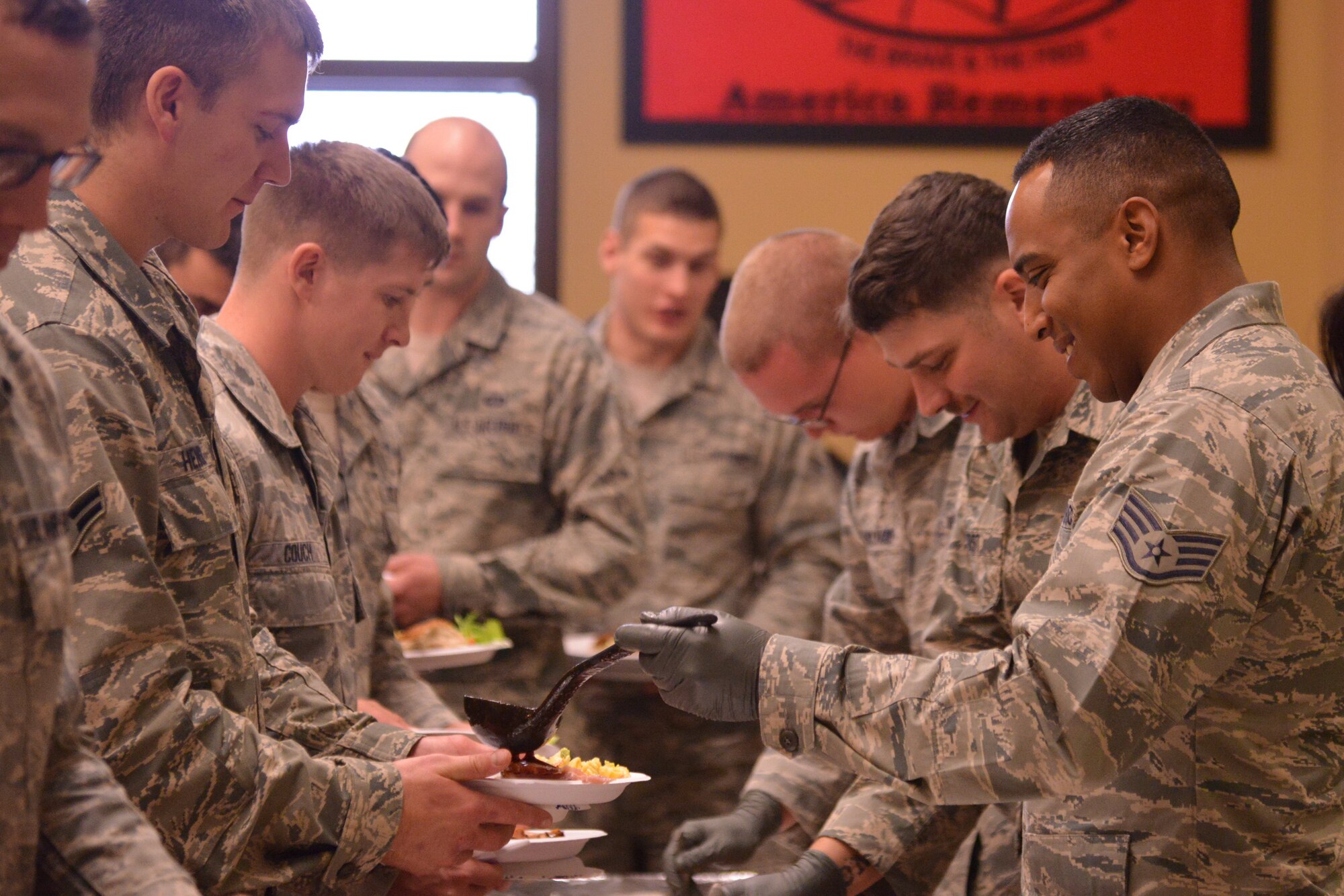 Pararescue trainees from the 342nd Training Squadron, Detachment 1, enjoy a Thanksgiving meal. The event, which has become an annual tradition, was organized by members of the AFRL Contracting Division with the help of donations from the local community.  (Photo by Ken Moore)