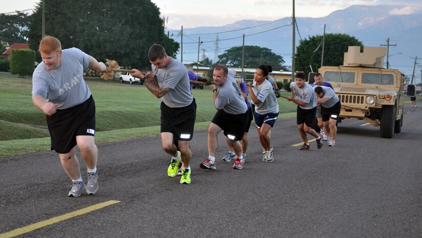 The officers of Joint Task Force-Bravo participated in a special physical training session, during which they competed in an "Urban Hero Challenge" at Soto Cano Air Base, Honduras, Nov. 22, 2013. The officers divided into teams and competed in events that included pushing and pulling a Humvee, tire-flipping, a fire-hose carry relay race, along with several others. The winning team of the competition earned the right to hoist Joint Task Force-Bravo Commander Thomas Boccardi's "PT Championship Belt." The special PT session served to enhance camaraderie, teamwork, and esprit de corps among the JTF-Bravo officers, as well as to promote overall physical fitness. (U.S. Air Force photos by Capt. Zach Anderson)