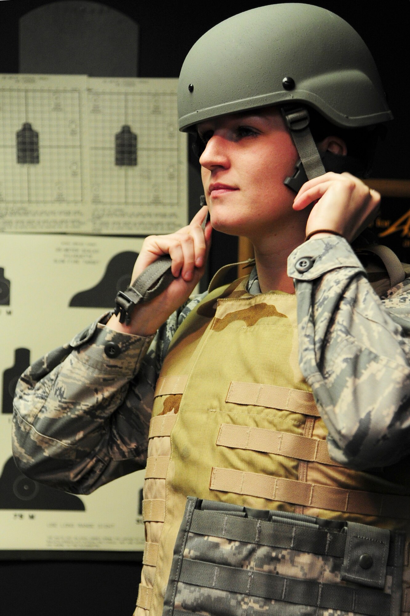 ALTUS AIR FORCE BASE, Okla. -- U.S. Air Force Senior Airman Krystal Brittain, 97th Operations Support Squadron airfield management specialist, dons her Advanced Combat Helmet during combat arms training Nov. 21, 2013. Airmen are required to wear protective equipment when going through weapons qualification training. (U.S. Air Force Photo by Senior Airman Lausanne Genuino/Released)
