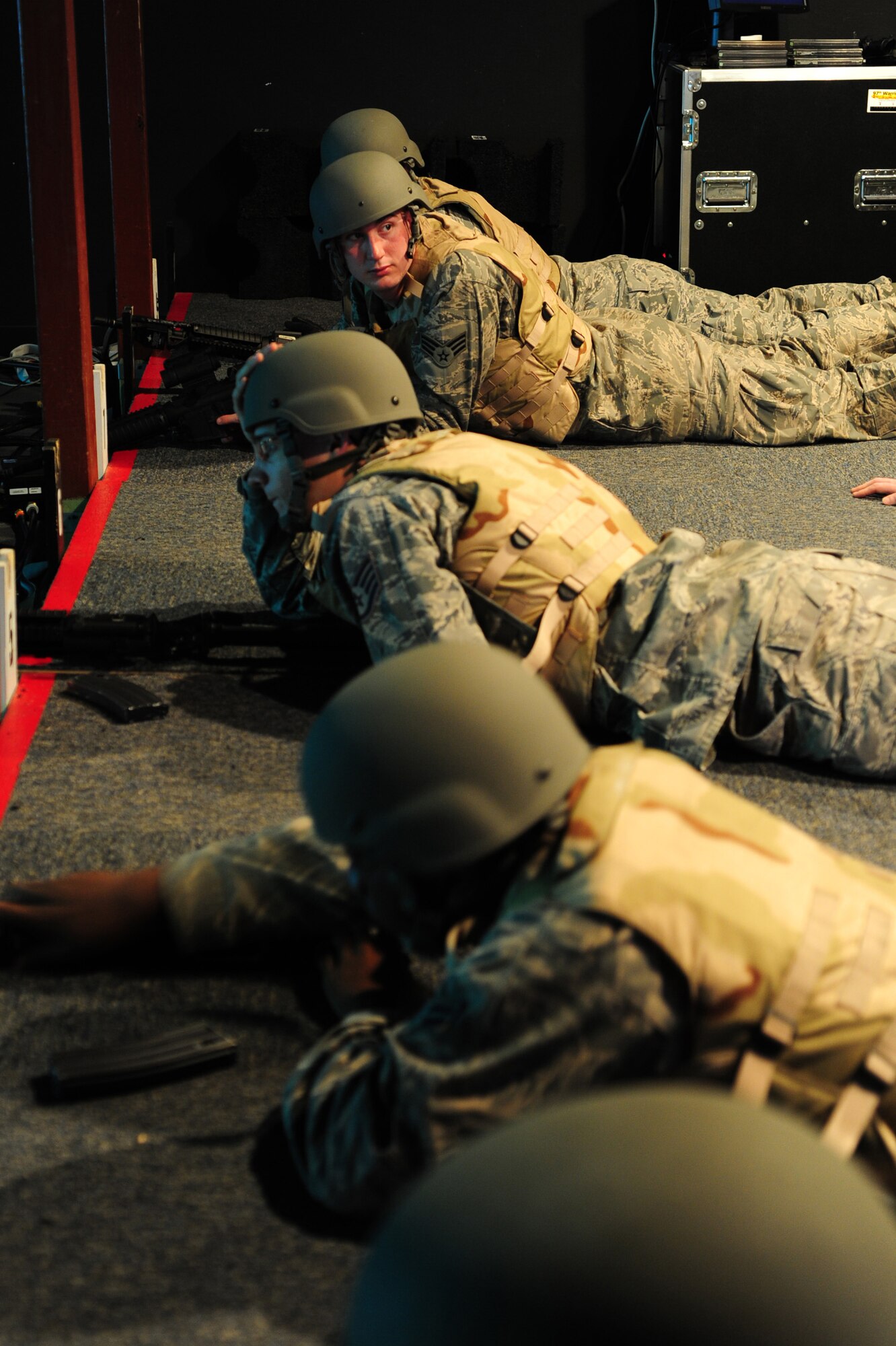 ALTUS AIR FORCE BASE, Okla. -- Expeditionary skills students await instruction during a combat arms class using the Engagement Skills Trainer 2000 training simulator Nov. 21, 2013. The EST 2000 allows Airmen to get more familiarized with shooting various weapons prior to firing at the weapons range. (U.S. Air Force Photo by Senior Airman Lausanne Genuino/Released)