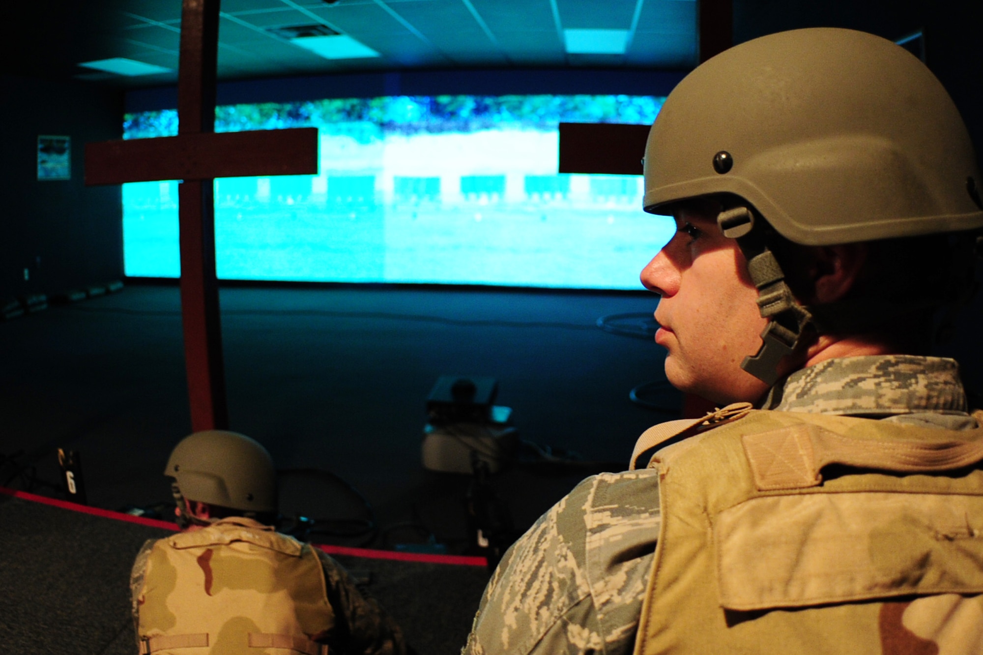 ALTUS AIR FORCE BASE, Okla. -- U.S. Air Force Staff Sgt. Michael Boseman, 97th Logistics Readiness Squadron vehicle operator, listens to feedback from the instructor during a combat arms class using the Engagement Skills Trainer 2000 training simulator Nov. 21, 2013. Airmen are required to go through weapons training prior to deploying in support of global contingency operations. (U.S. Air Force Photo by Senior Airman Lausanne Genuino/Released) 