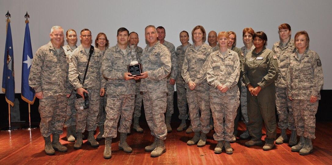 Fourth Air Force commander, Brig. Gen. John Flournoy, Jr., (center), presents the Major General Joseph A. McNeil Award (small wing category) for Human Resource Development Excellence, to the commander of the 932nd Airlift Wing, Col. Albert Lupenski (at left,) and the rest of the HRDC council members of the Illinois unit. (U.S. Air Force photo / Staff Sgt. Amber Hodges)