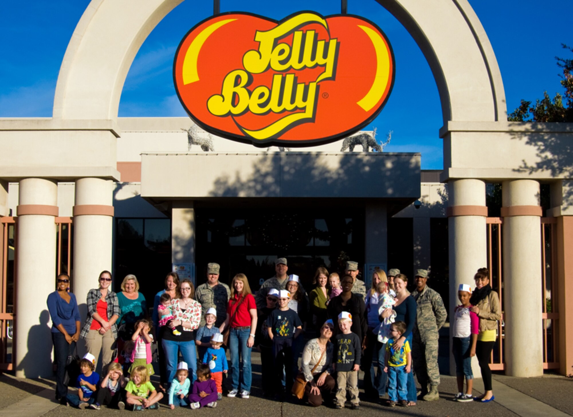 Airmen and families pose at the entrance to the Jelly Belly Candy Co. factory in Fairfield. (U.S. Air Force Charles Rivezzo)