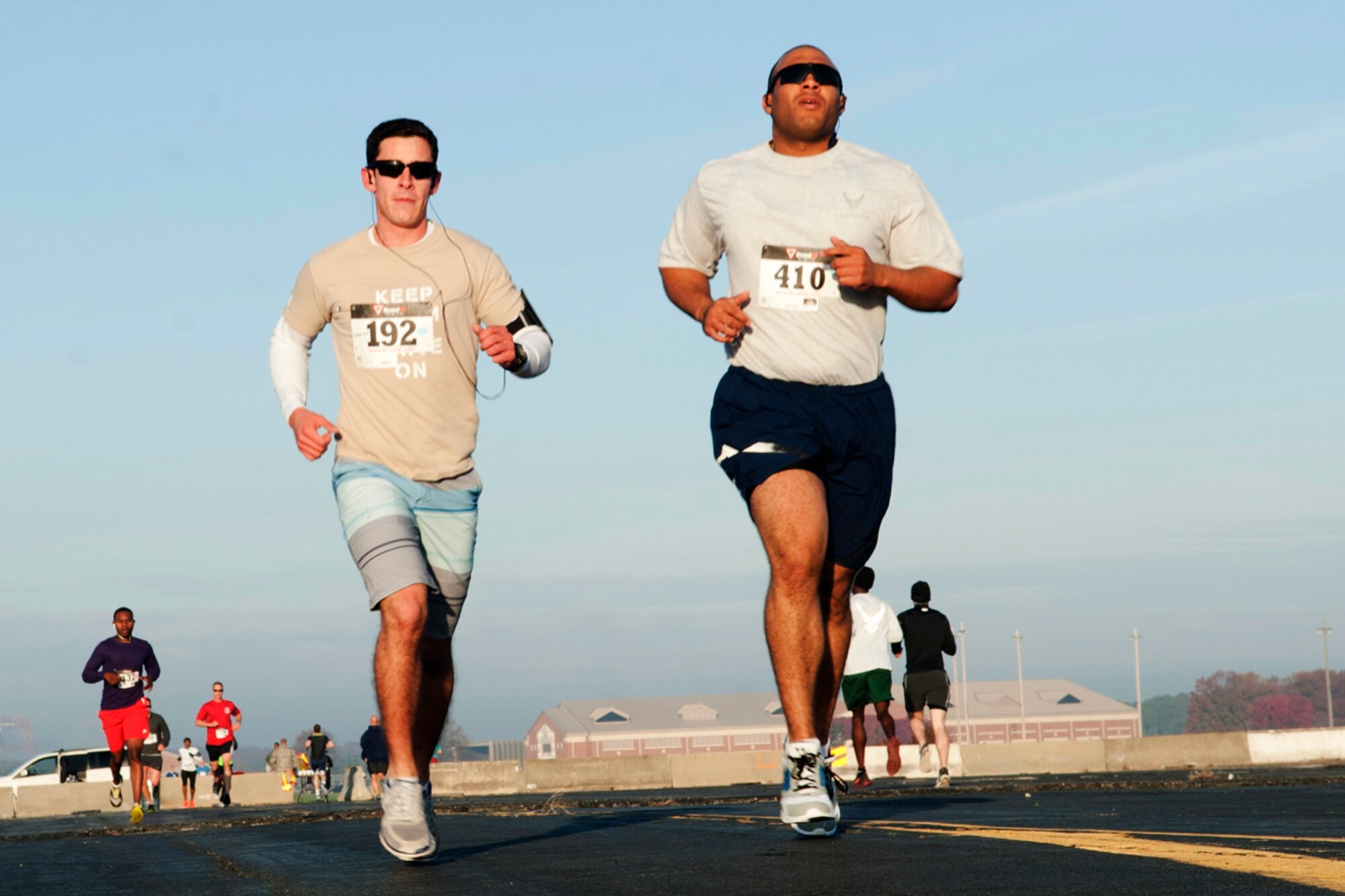 U.S. Air Force Airmen  run on the flightline during the Langley First Sergeants Council 5K “Gobble Wobble” at Langley Air Force Base, Va., Nov. 22, 2013. The council collected monetary and food donations to support Operation Warmheart. (U.S. Air Force photo by Airman Areca T. Wilson/Released)