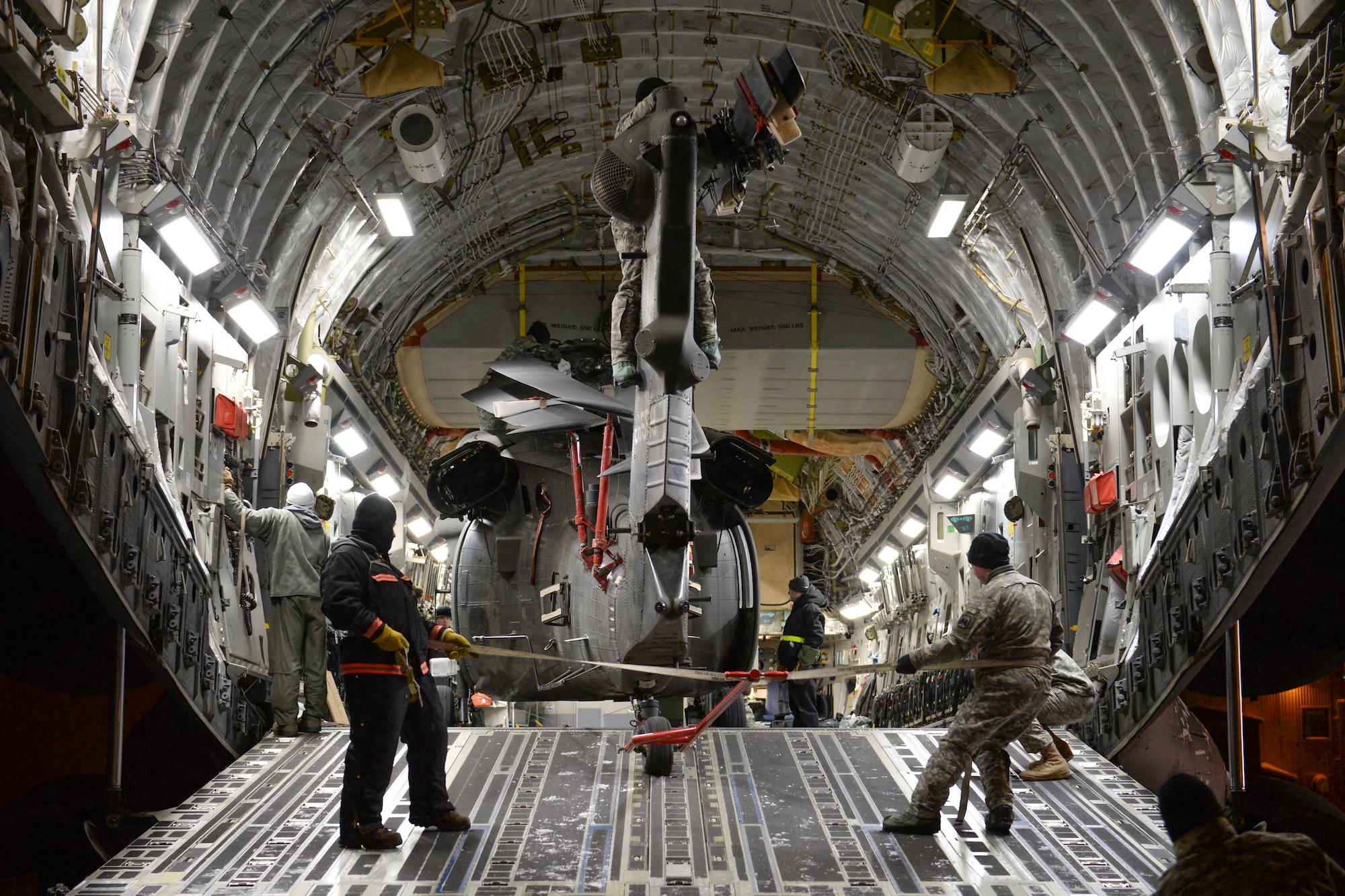 U.S. Army Soldiers from Fort Wainwright, Alaska, unload a UH-60 Black Hawk helicopter and equipment from a U.S. Air Force C-17 Globemaster III assigned to the 452nd Air Mobility Wing, March Air Reserve Base, Calif., Nov. 18, 2013, Eielson Air Force Base, Alaska. The 452nd AMW assisted U.S. Army Soldiers stationed at Fort Wainwright, Alaska, in returning helicopters and equipment from a deployed location.  (U.S. Air Force photo by Airman 1st Class Peter Reft/Released)
