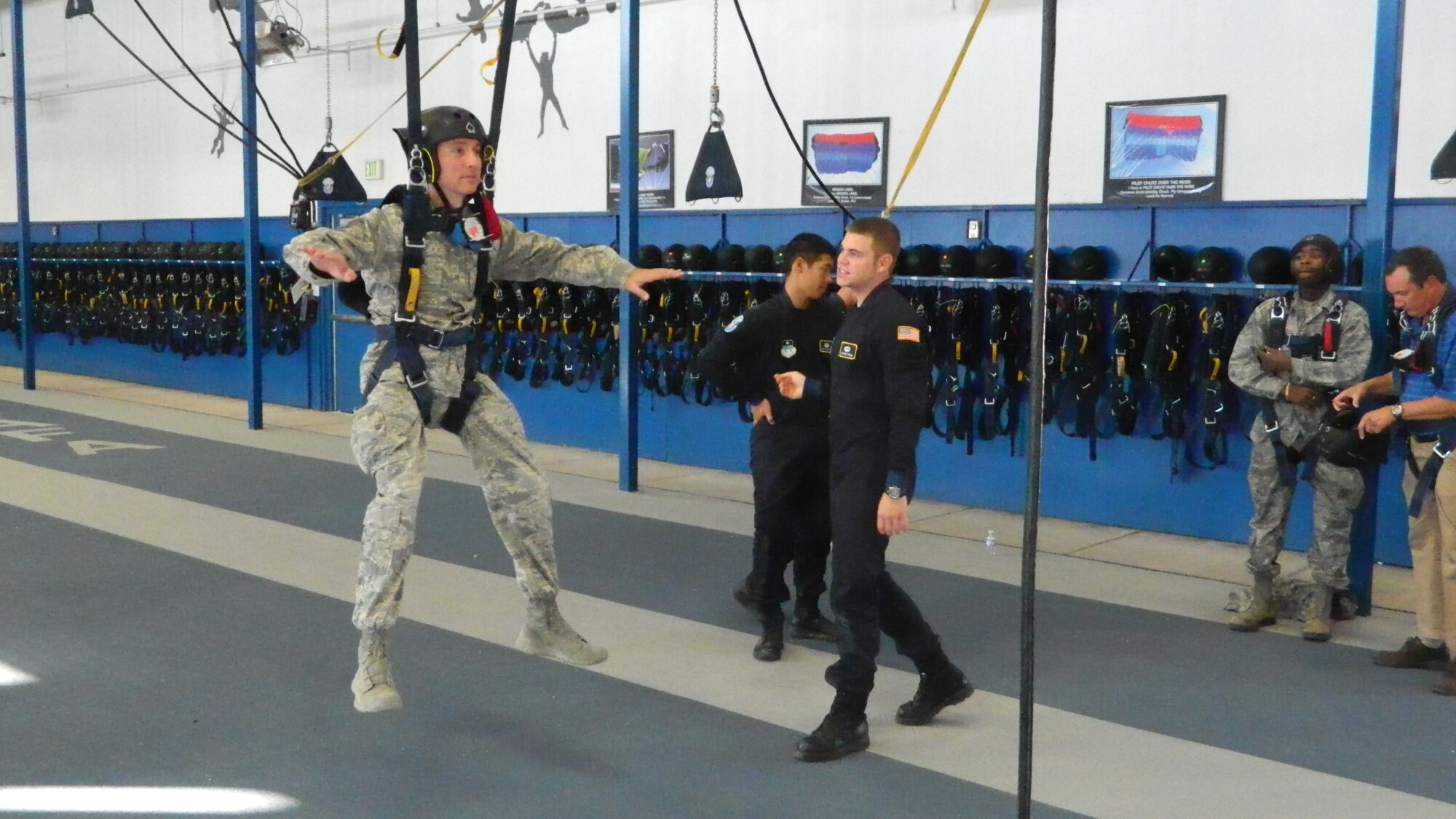 Tech. Sgt. Judah Vann is lifted off the ground during a Wingman Day parachute demonstration in an Academy airfield Nov. 14. Vann is assigned to the 10th Medical Support Squadron