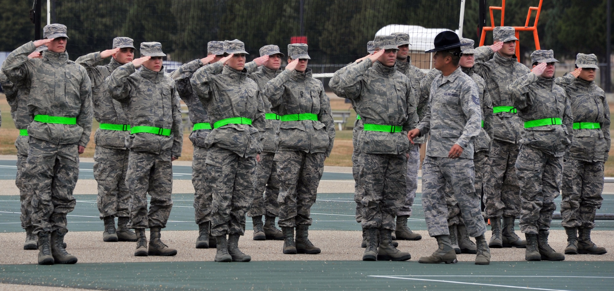 Officer trainees are taught the proper way to salute by Tech. Sgt. Chi Yi, Officer Training School military training instructor, during their first day of drill instruction at OTS. Training instructors teach drill and ceremony to instill discipline, attention to detail and military bearing in the offier trainees.  (U.S. Air Force Photo by Staff Sgt. Gregory Brook)
