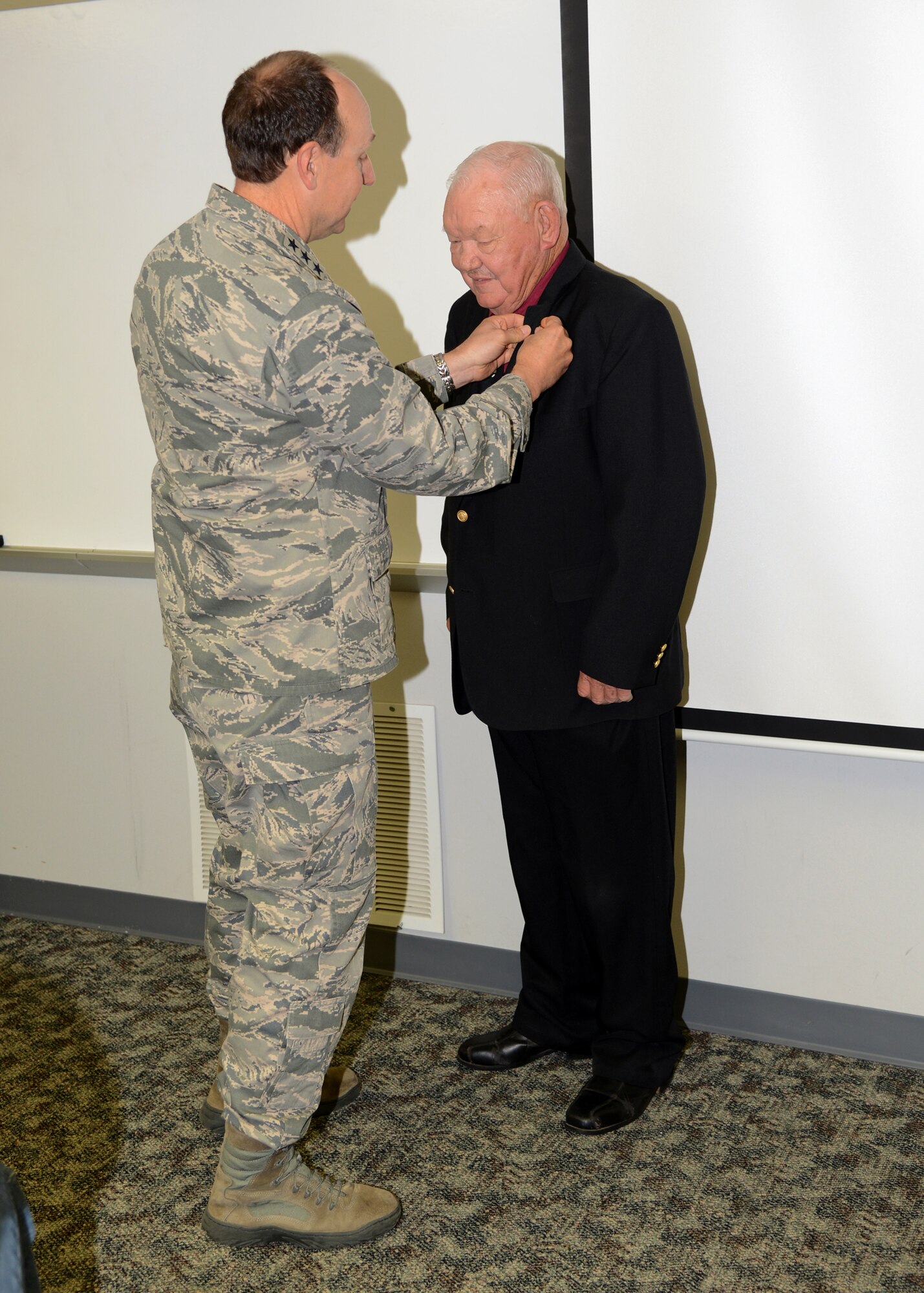 Dr. Troy Corder, an education specialist with the 72nd Force Support Squadron, was awarded his 50-year pin and certificate on Tuesday by Air Force Sustainment Center Commander Lt. Gen. Bruce Litchfield. Dr. Corder has worked as a civil servant at Tinker for 47 years and served three years in the Army. (Air Force photo by Kelly White)