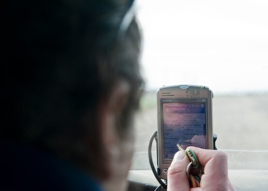 David Curtiss, 436th Airlift Wing Safety Office wildlife manager, marks the location of where he found birds on his GPS Nov. 20, 2013, near Dover Air Force Base, Del. Curtiss uses his GPS to not only mark where he found birds, but what actions he took to keep them out of the flight path of Team Dover. (U.S. Air Force photo/Senior Airman Jared Duhon)