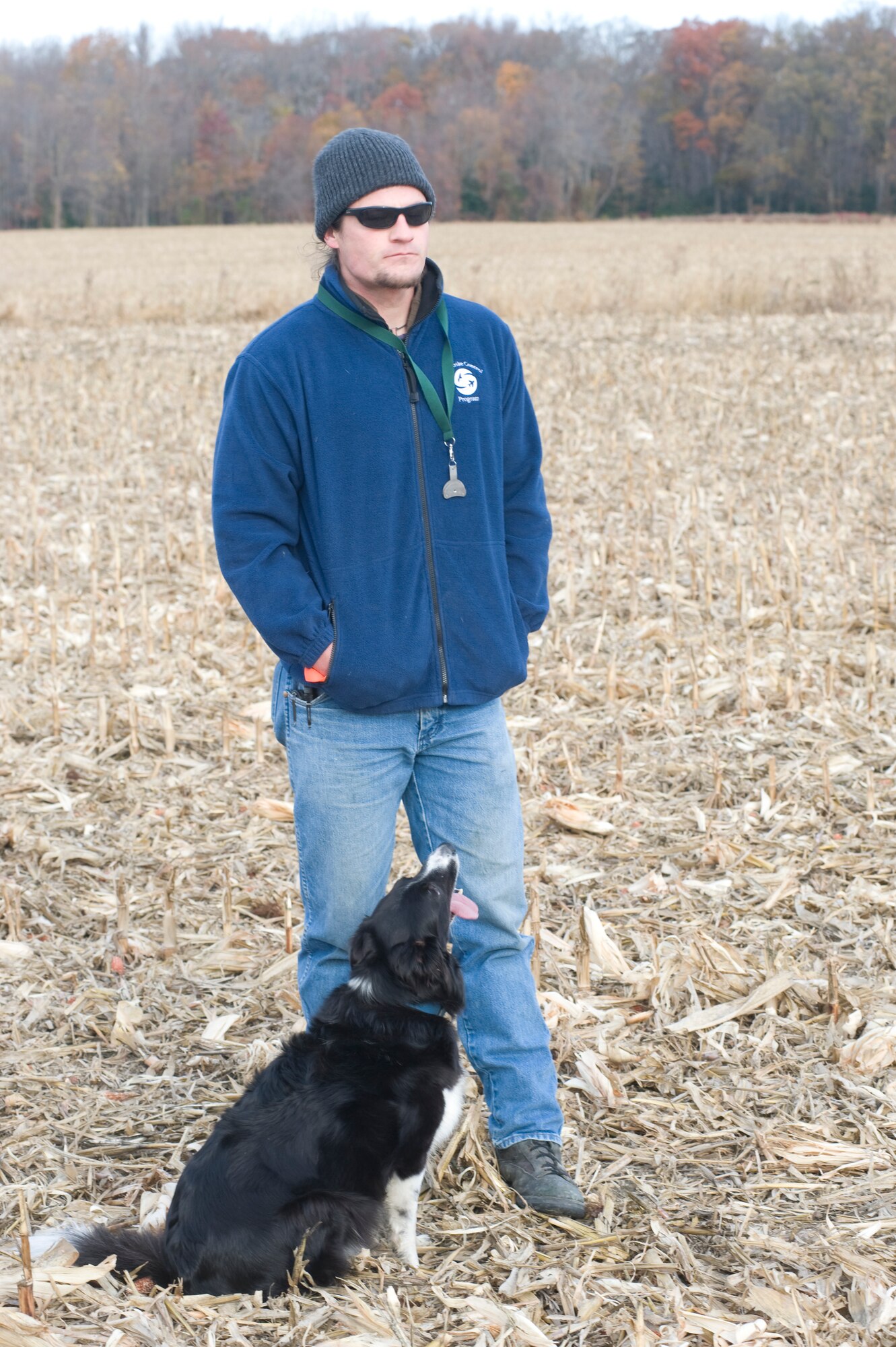 David Curtiss, 436th Airlift Wing Safety Office wildlife manager, and “Kilo” watch the flight pattern of geese ensuring they are moving away from the base Nov. 20, 2013, near Dover Air Force Base, Del. Curtiss and Kilo battle each day to keep birds out of the flight path of Team Dover. (U.S. Air Force photo/Senior Airman Jared Duhon)