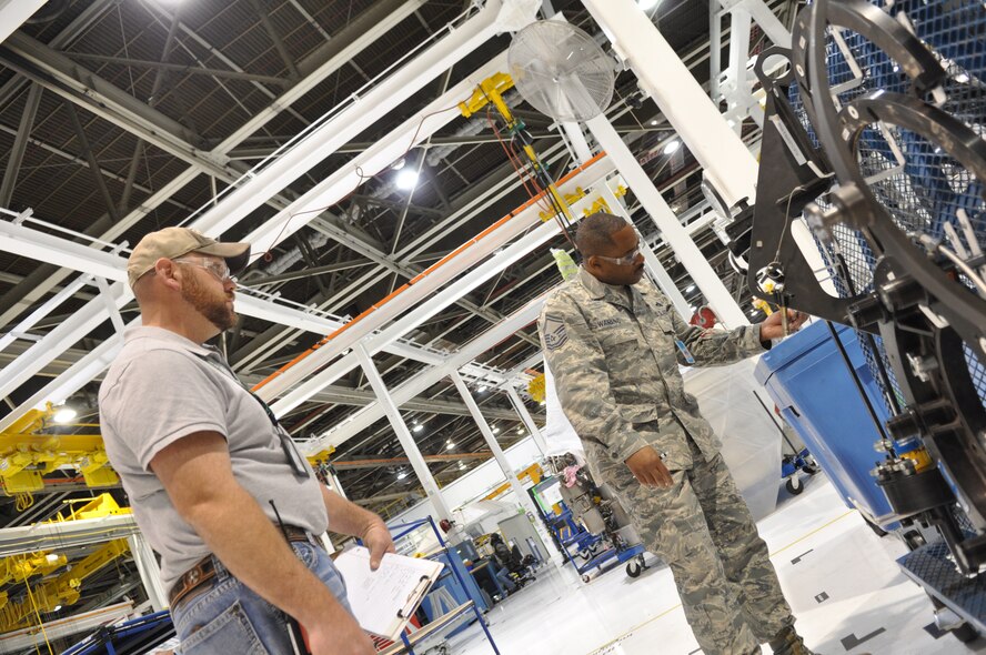 Senior Master Sgt. Wilfred Waring, a member of the Air Force Materiel Command Inspector General team, examines engine adapters, support equipment for F117 engine maintenance at the Oklahoma City Air Logistics Complex’s 544th Propulsion Maintenance Squadron. Sergeant Waring, accompanied by 544th PMXS member, Erik McMillan, conducted his inspection as part of the Logistics Process Assessment. The LPA is just one of several inspections that representatives of AFMC, Air Combat Command and Air Force Reserve Command Inspectors General offices conducted beginning Nov. 18. (Air Force photo by Micah Garbarino)