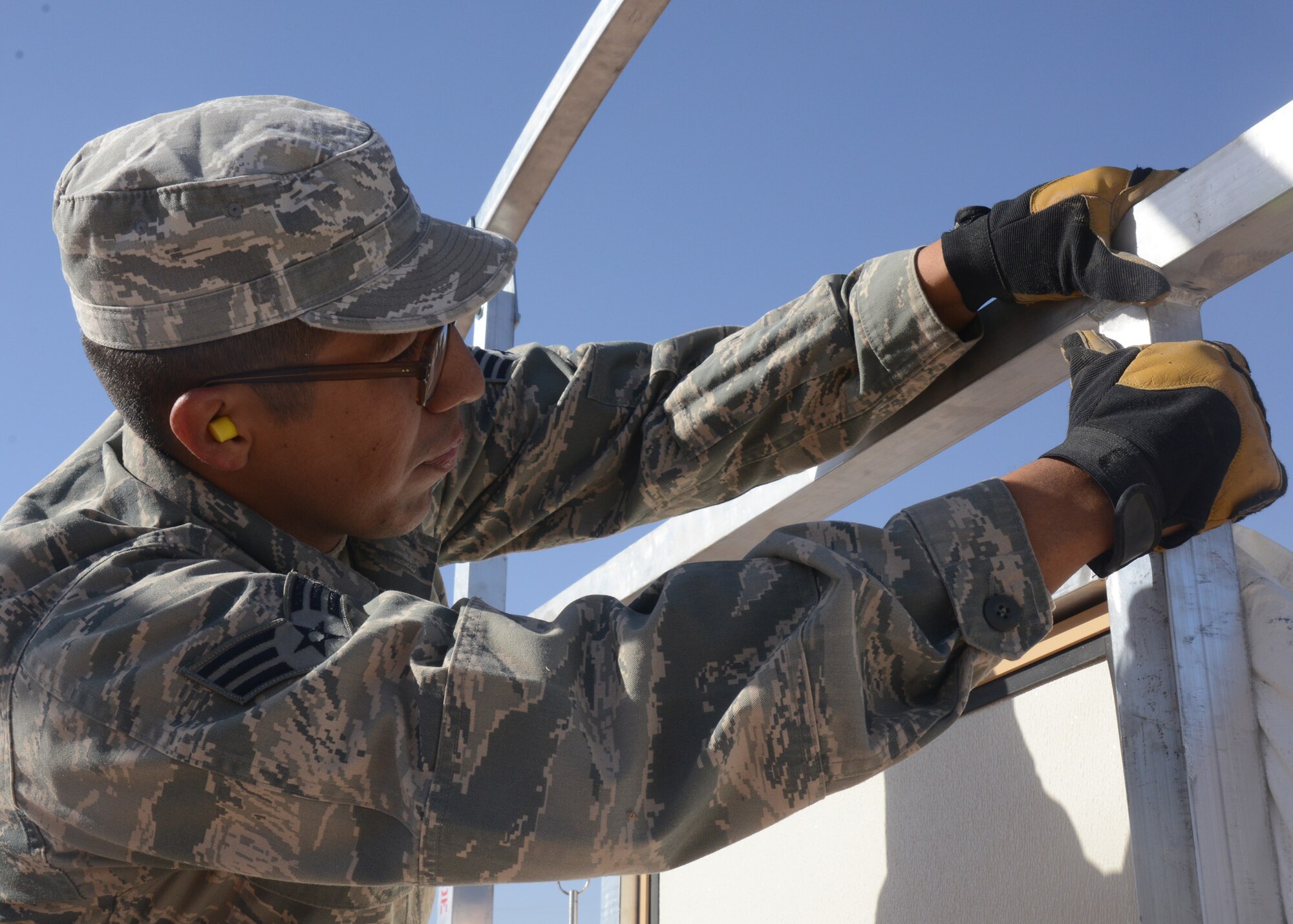 Senior Airman Emilio Cardenas-Martinez, 56th CES electrician, fixes the frame on a door. (U.S. Air Force photo/Airman 1st Class Devante Williams)
