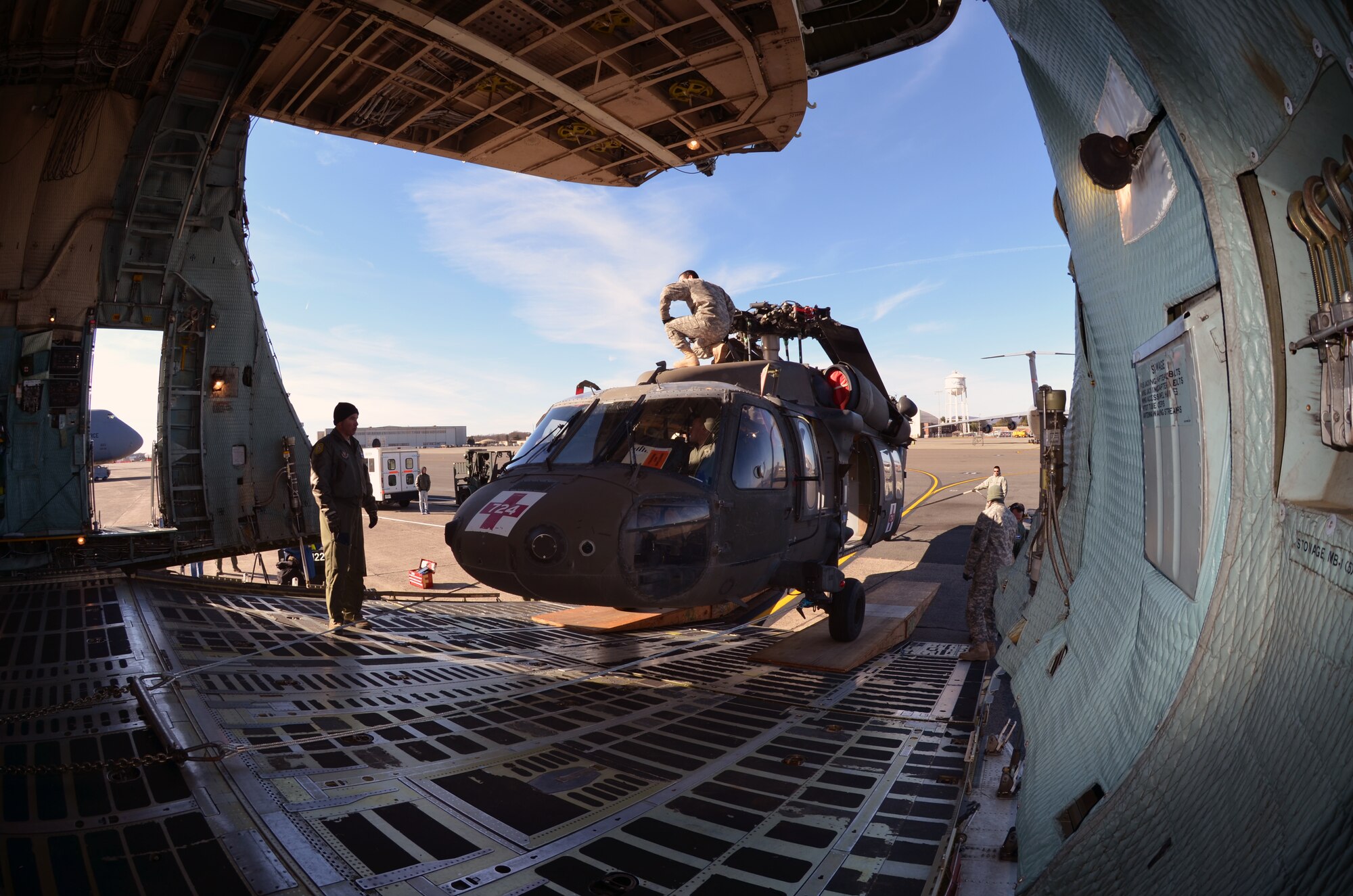 Airmen from Westover join soldiers from the Operational Support Airlift Agency, Detachment 18, New Hampshire Army National Guard, to load UH-60 Medical Evacuation helicopters aboard Westover’s massive C-5B Galaxy, Nov. 19, 2013. The Air Force reservists and Army Guardsmen successfully loaded and transported three medical evacuation choppers to Gray Army Airfield, Joint Base Lewis-McChord, Wash., saving the government $870,000 flying cost and 1,800 total man-hours. (U.S. Air Force photo/SSgt. Kelly Goonan)