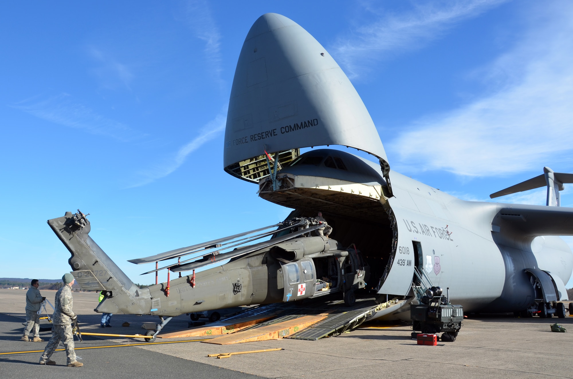 Westover Airmen team with Soldiers from the New Hampshire Army National Guard to load their UH-60 Medical Evacuation helicopters onto the massive C-5 cargo aircraft November 19, 2013. Three UH-60 helicopters were successfully loaded and transported to Gray Army Airfield, Fort Lewis, Washington. (U.S. Air Force photo/SSgt. Kelly Goonan)