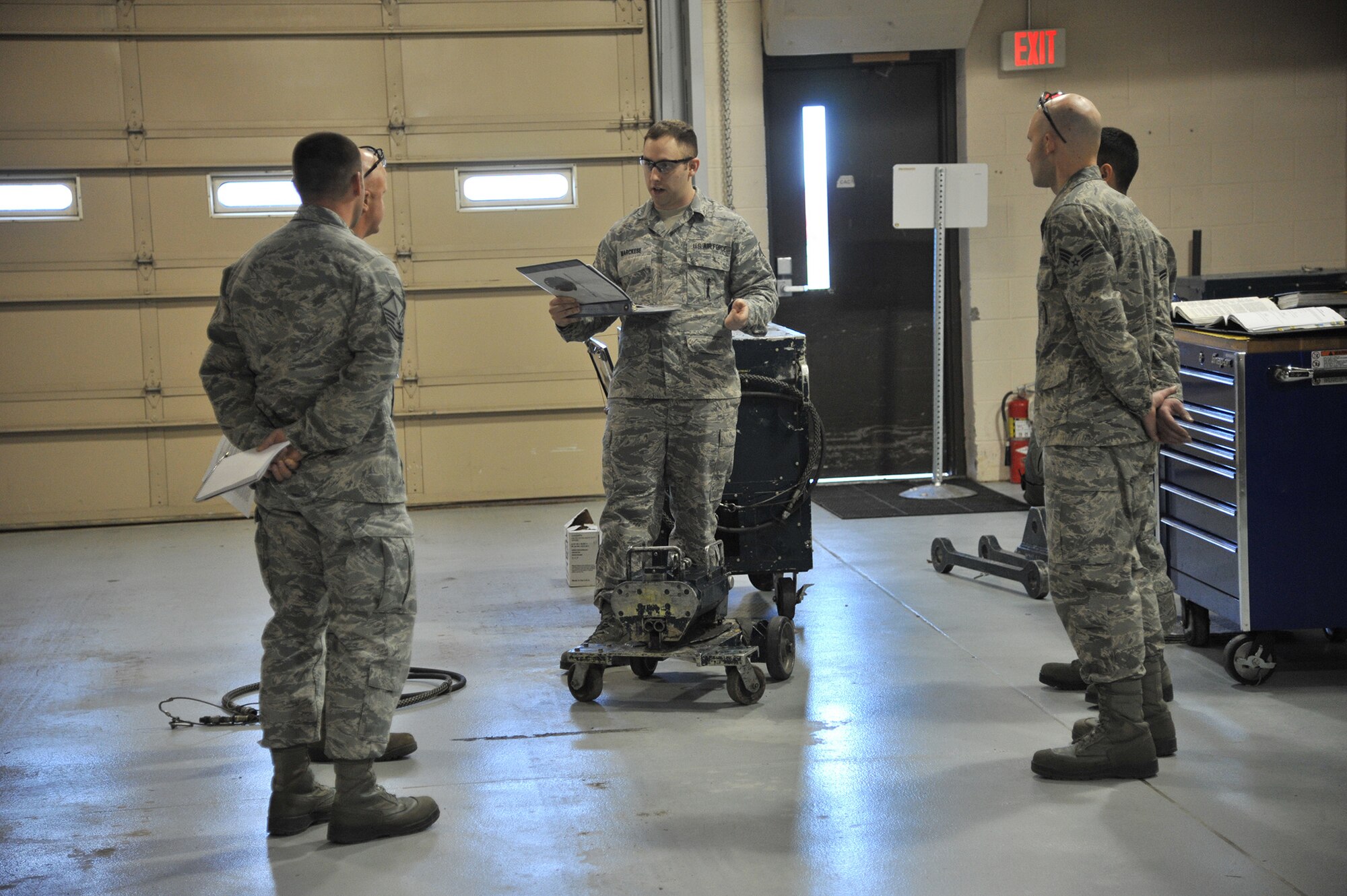 A member of the Air Force Global Strike Command Inspector General team (center) speaks to members of the 341st Maintenance Operations Squadron Mechanical Pneudraulics Section following his inspection of their daily operations Nov. 14 as part of the Nuclear Operations Readiness Inspection.  The weeklong inspection included detailed assessments of Malmstrom’s maintenance sections as well as various other areas of Malmstrom Air Force Base, including command and control, nuclear weapons system capabilities, munitions support, operations and mission execution.   (U.S. Air Force photo/John Turner)